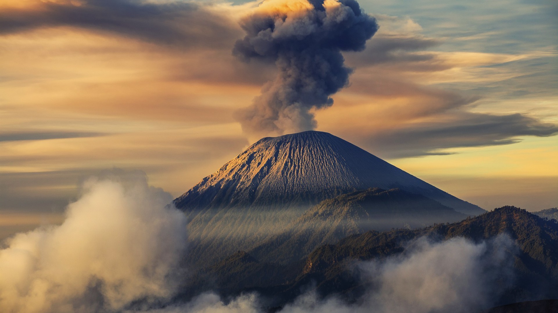 Volcano erupting smoke into the sky with clouds HD Wallpaper