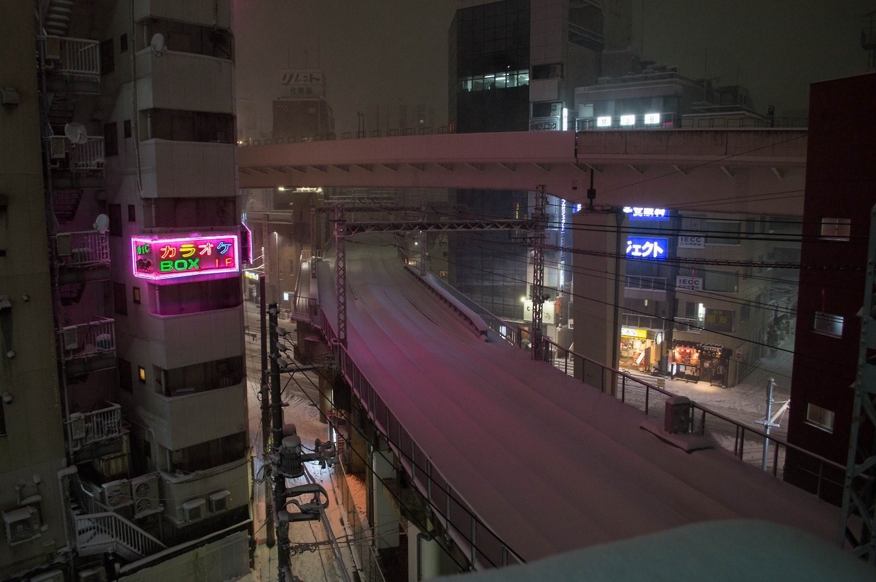 Snowy night in Japan with neon signs and elevated road HD Wallpaper