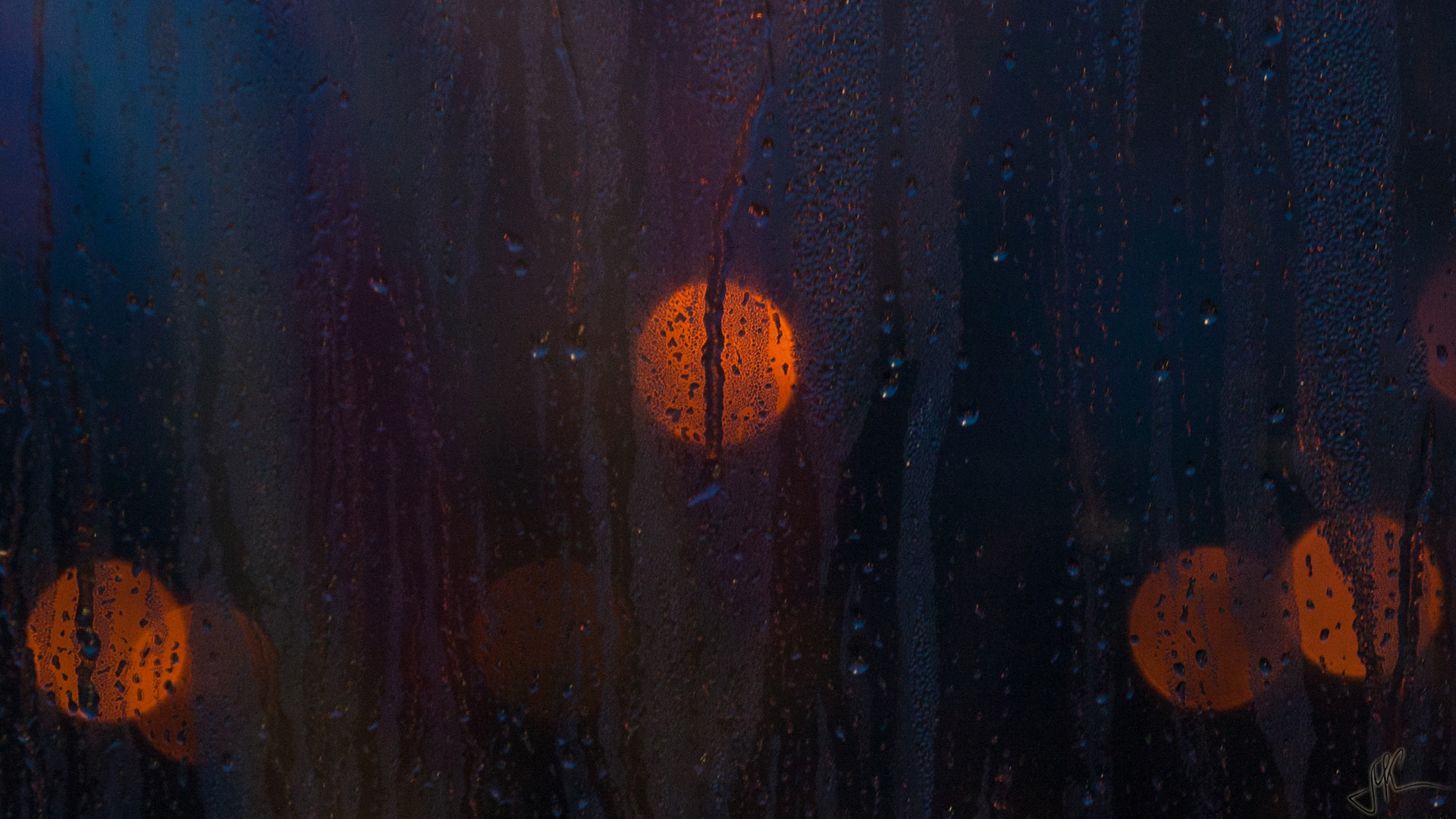 Bokeh lights through a rain-streaked window HD Wallpaper