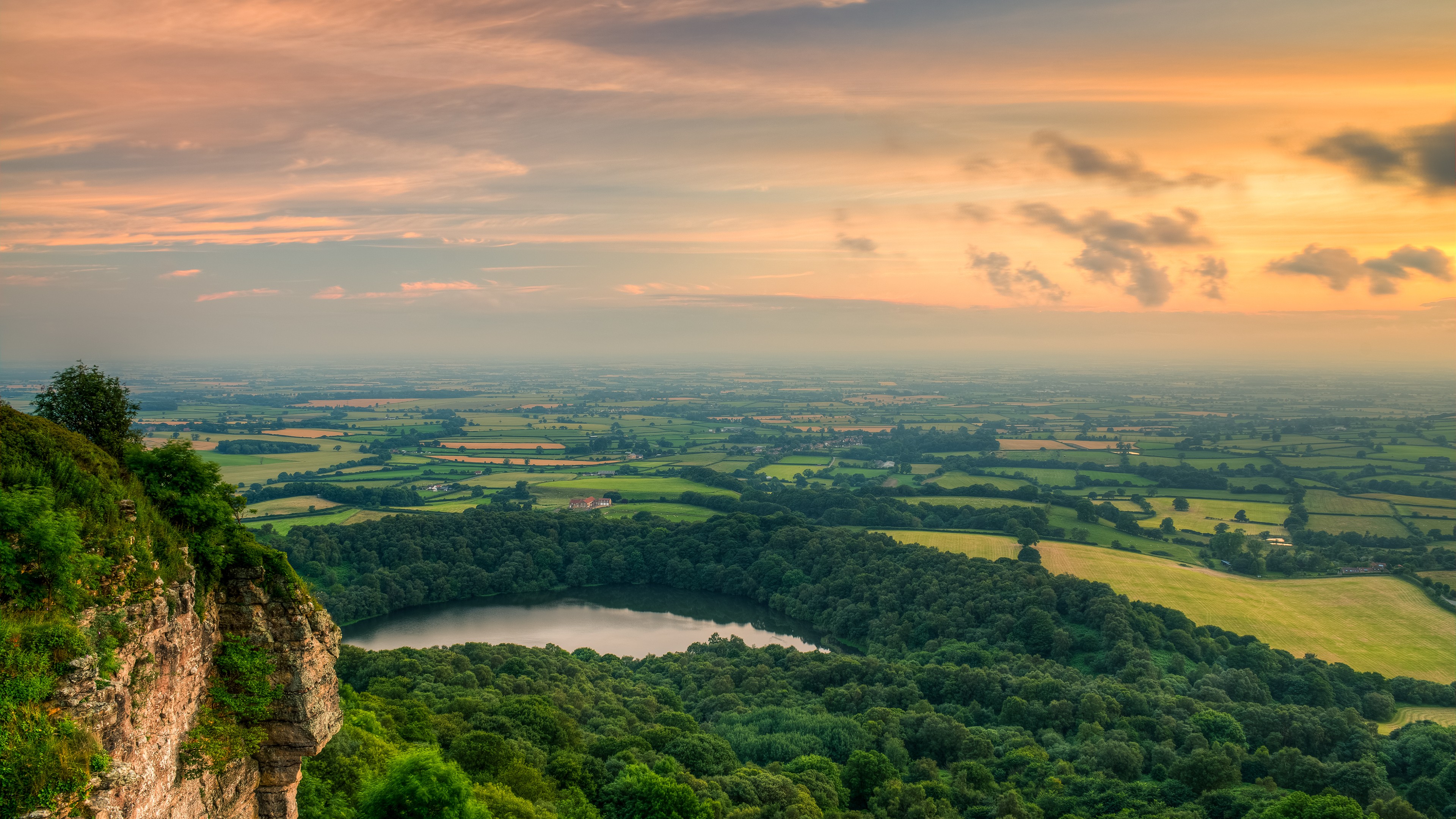 Overlook of a lake and rolling hills at sunset HD Wallpaper