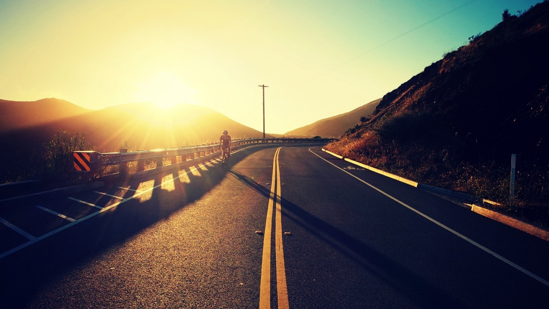 Biker on a road during sunset HD Wallpaper