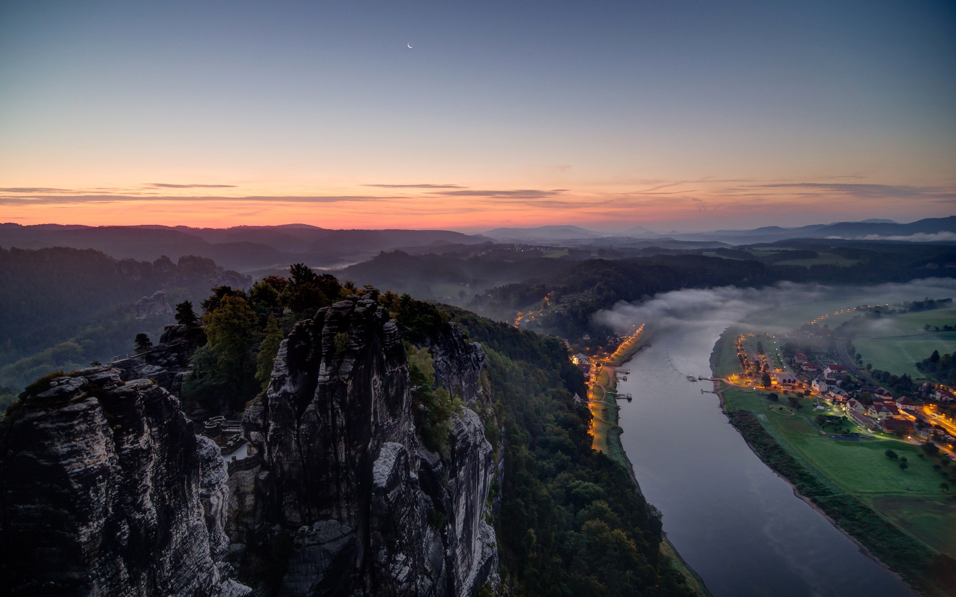 Misty river valley at sunset with rock formations HD Wallpaper