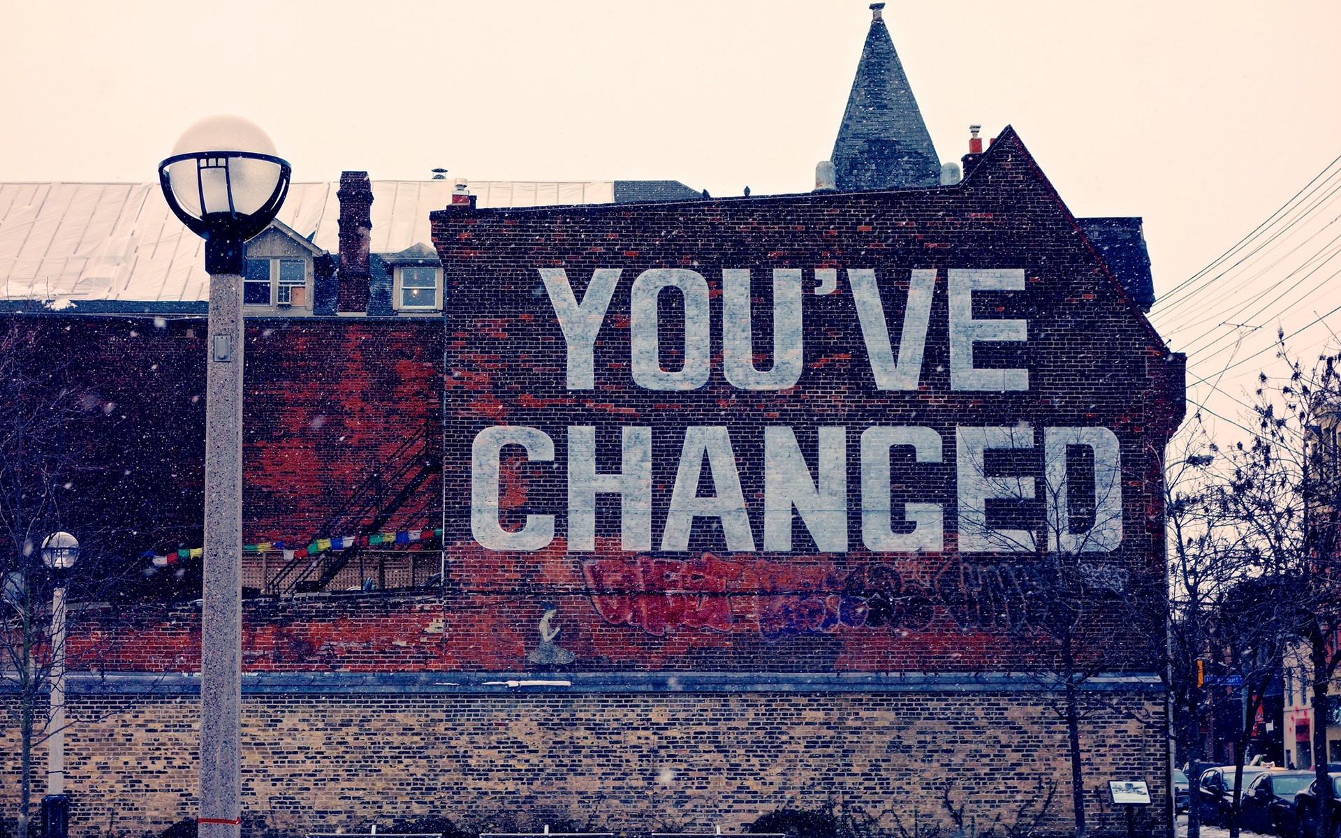 Graffiti on a brick building with a street light HD Wallpaper