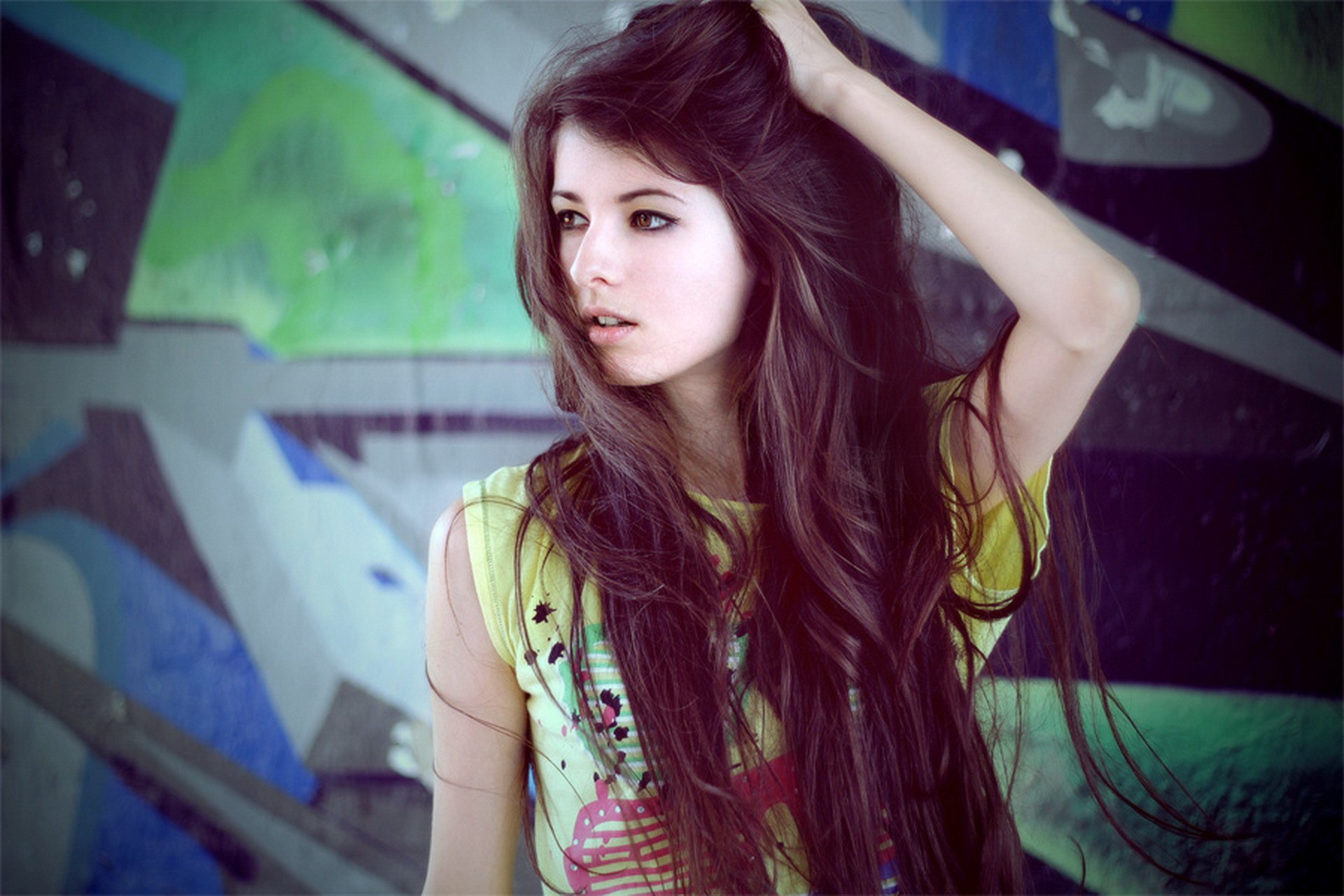 Brunette woman with long hair posing against graffiti HD Wallpaper