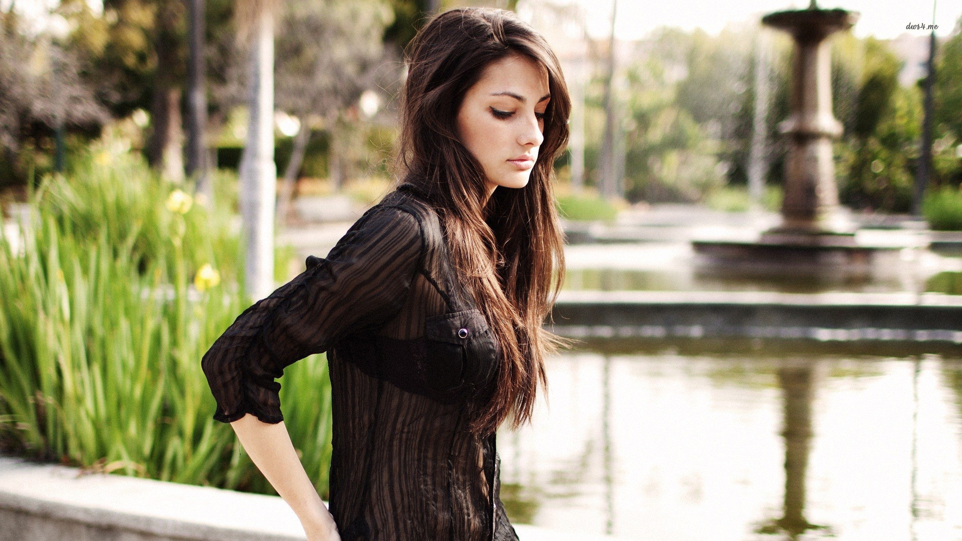 Woman with long brown hair wearing a sheer black shirt HD Wallpaper