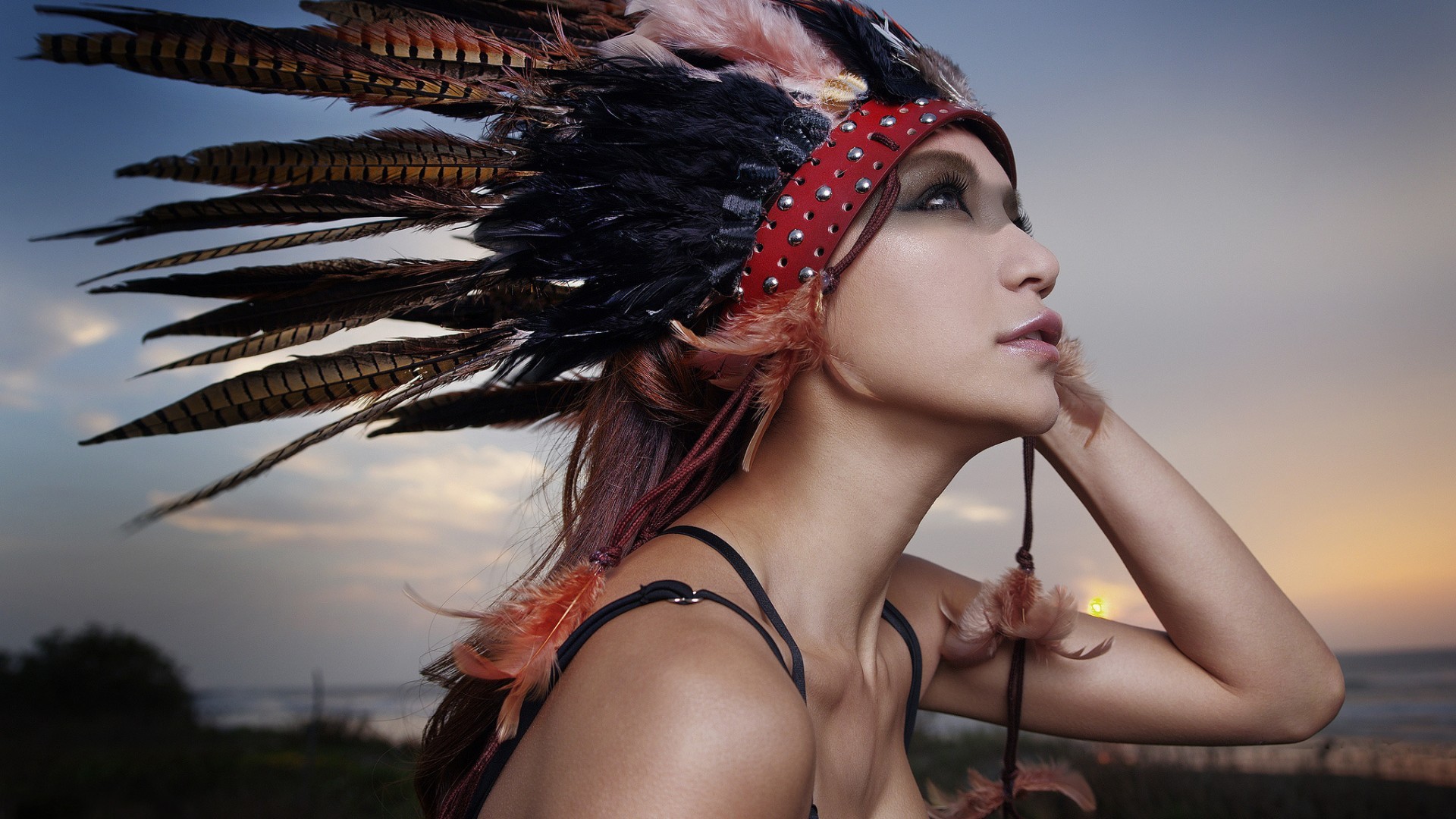 Woman wearing a Native American headdress at sunset HD Wallpaper