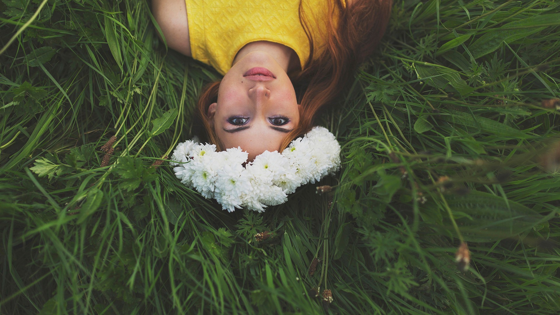 Woman with a flower crown lying in grass HD Wallpaper