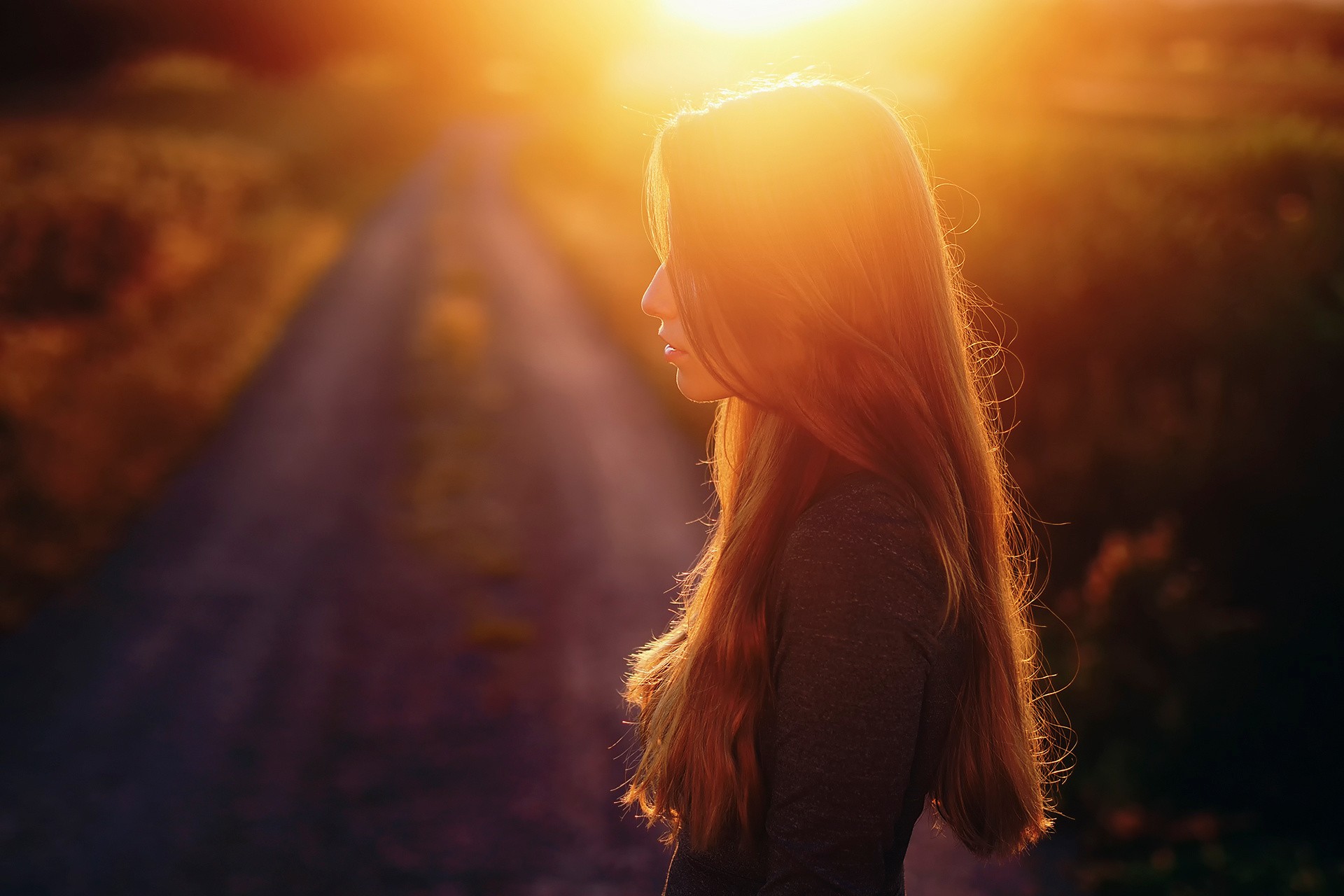 Woman with long hair in sunlight outdoors HD Wallpaper