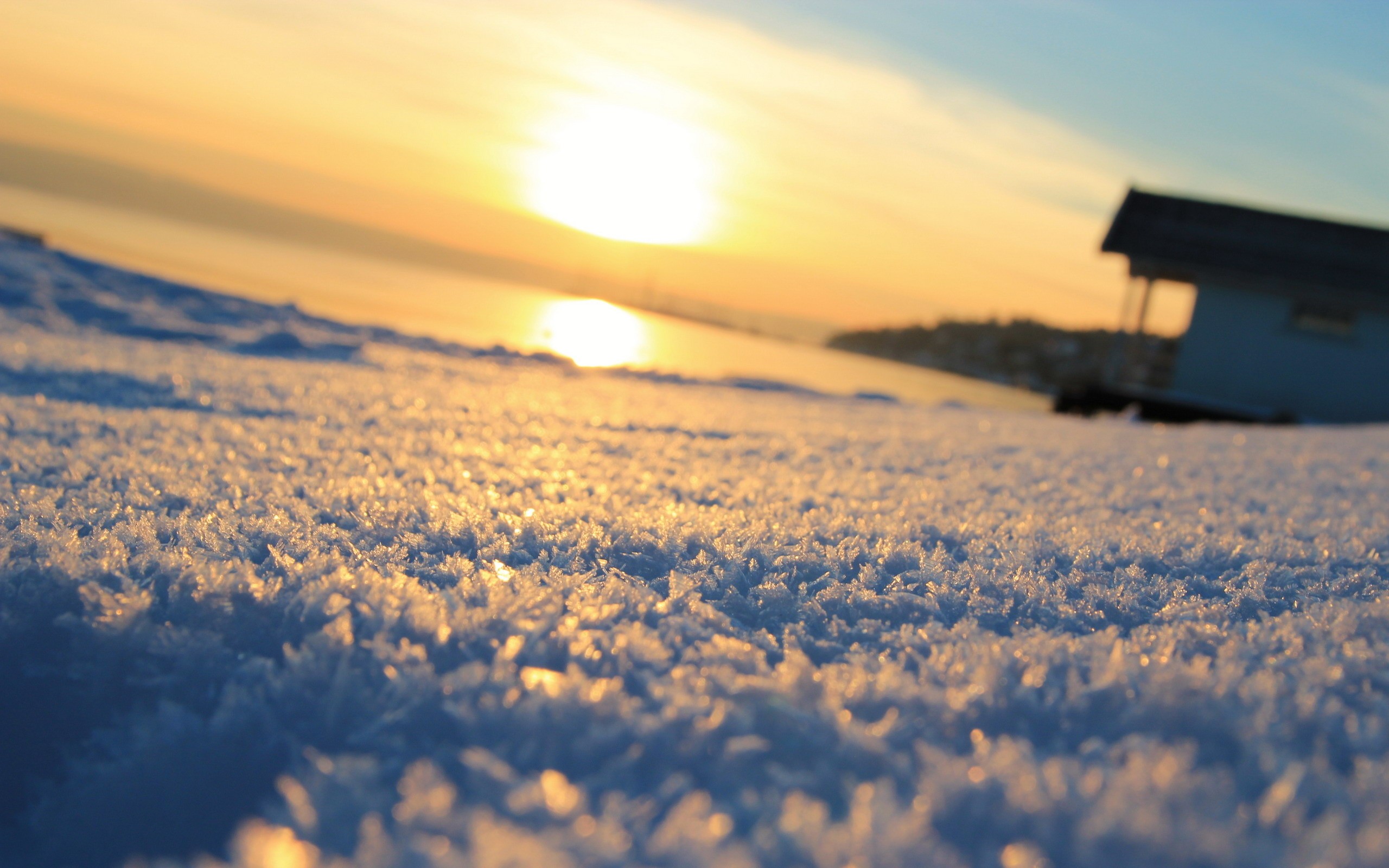 Frosty ground with a sunset and a small building HD Wallpaper
