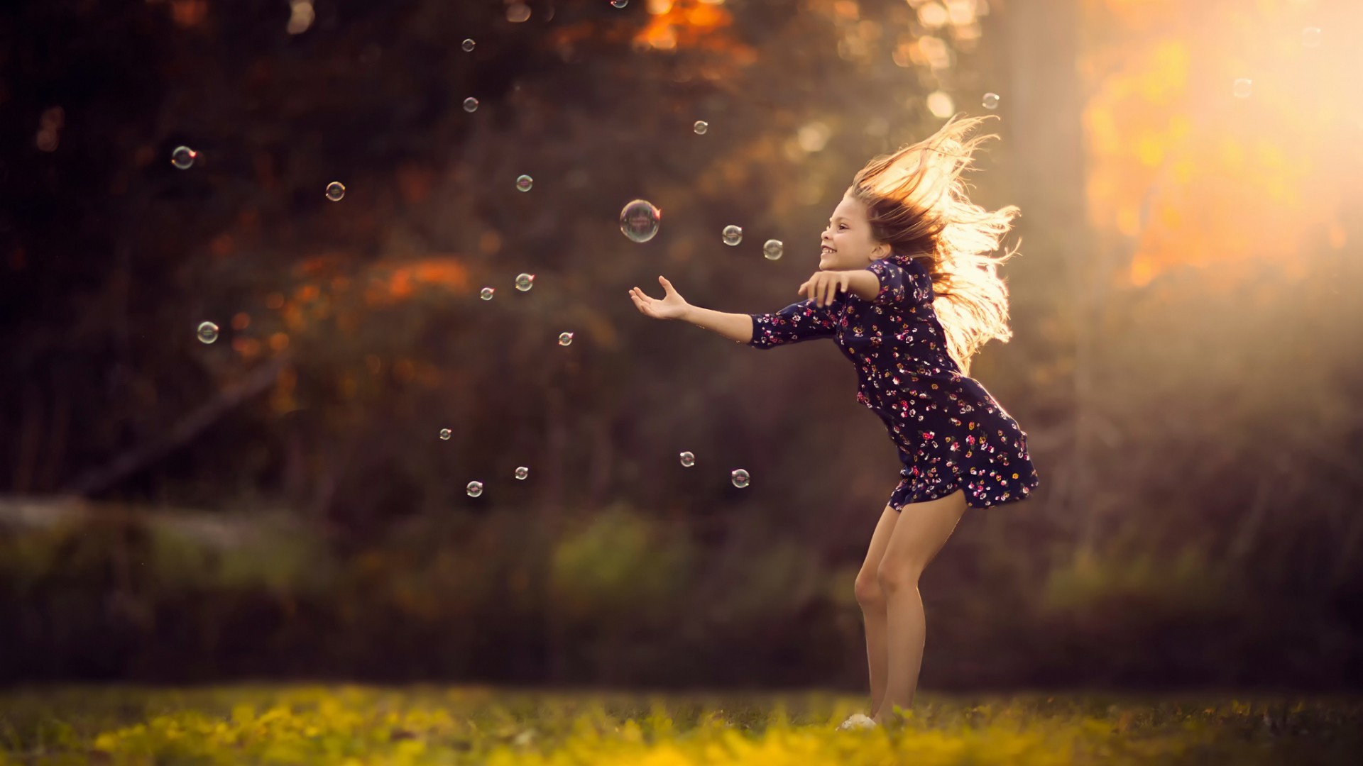 Little Girl Playing with Bubbles in Sunlight HD Wallpaper