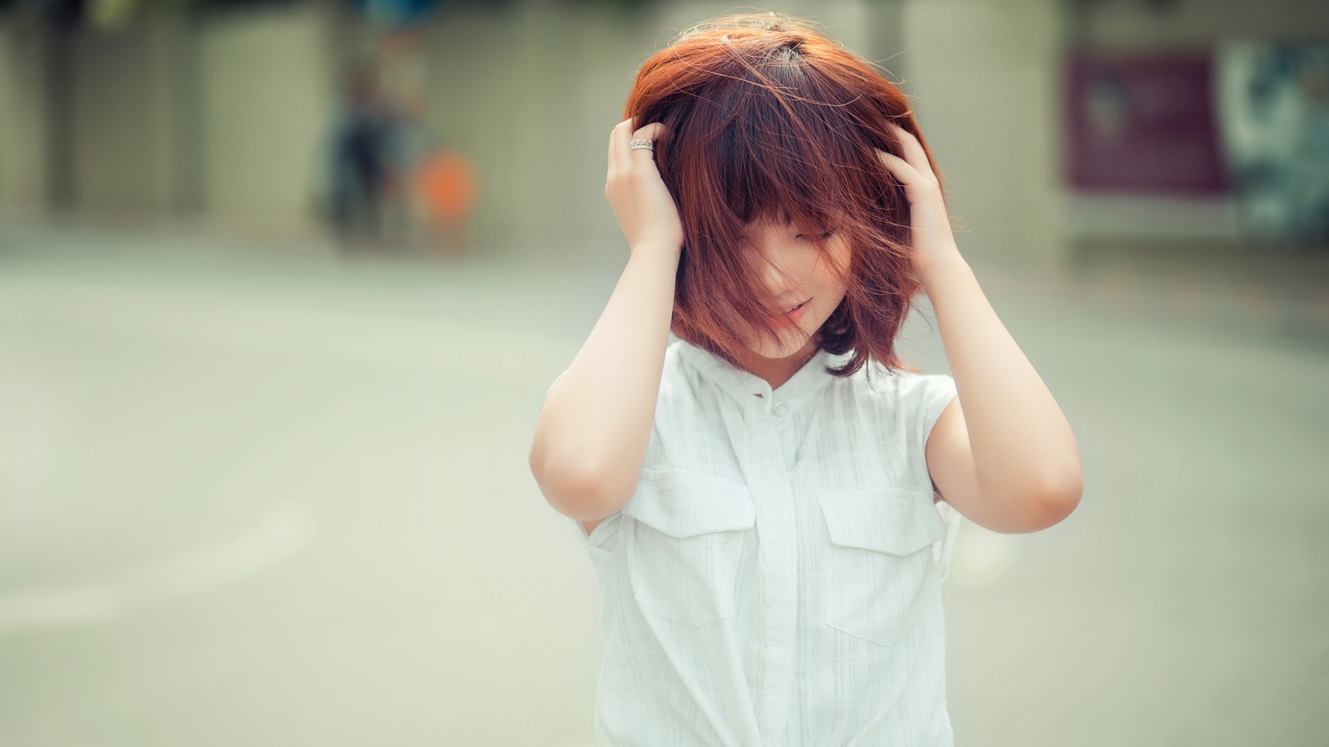Asian woman with short red hair touching her head HD Wallpaper