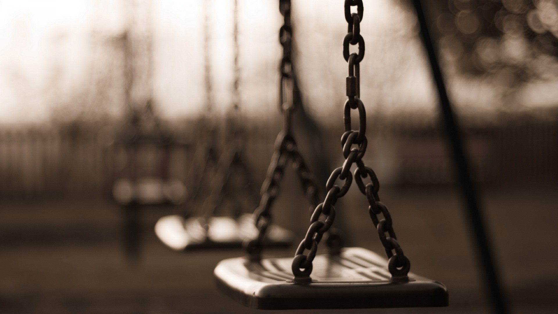 Sepia toned swings with chains and depth of field HD Wallpaper