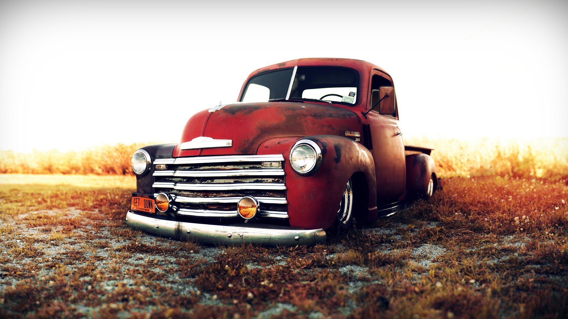 Red vintage Chevrolet truck in a field HD Wallpaper