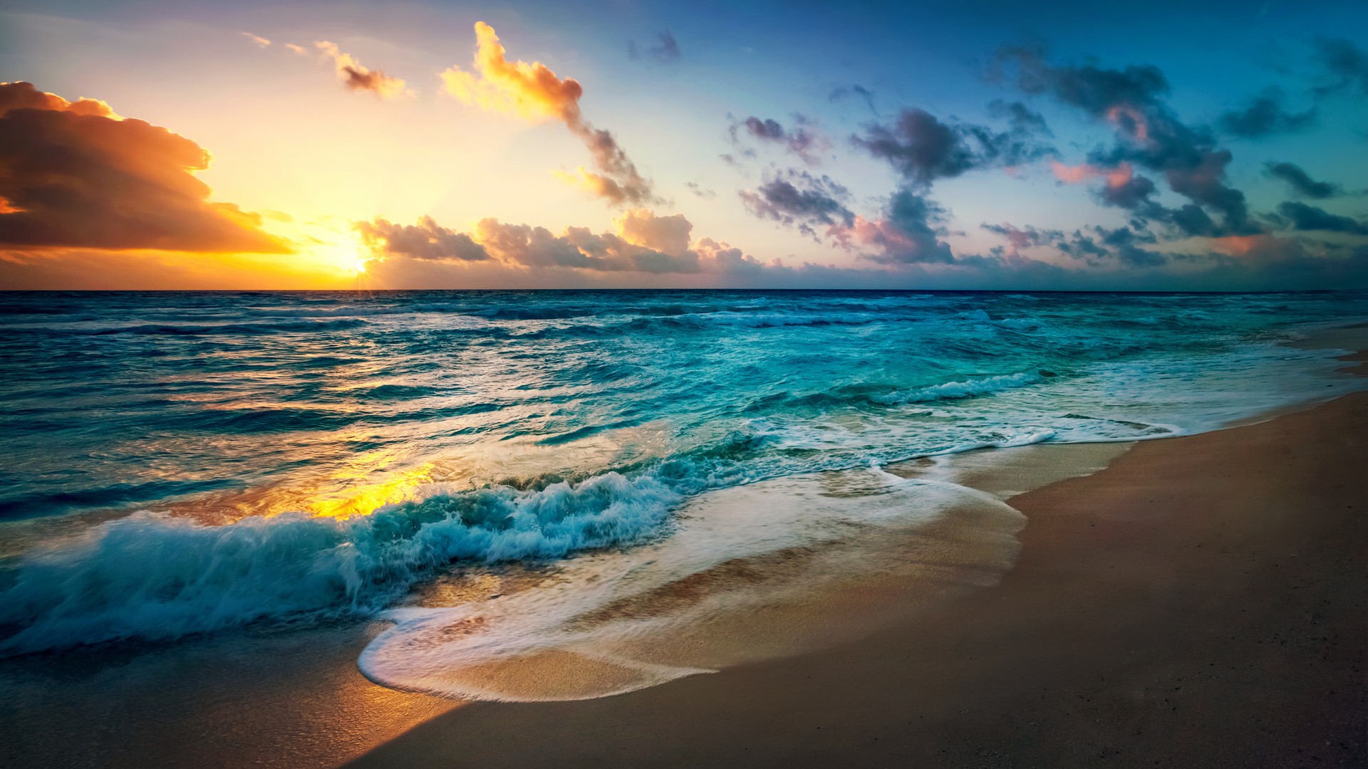 Ocean waves on a sandy beach at sunset HD Wallpaper