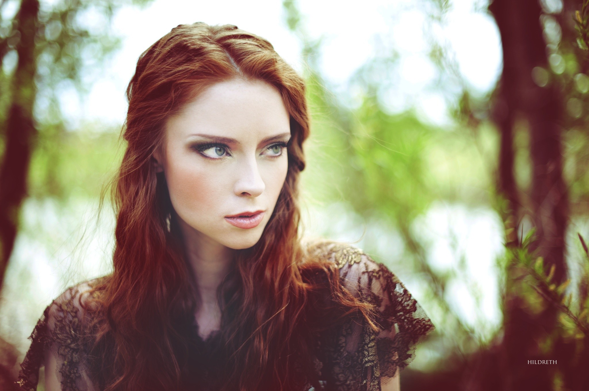 Redhead woman with green eyes in a forest HD Wallpaper