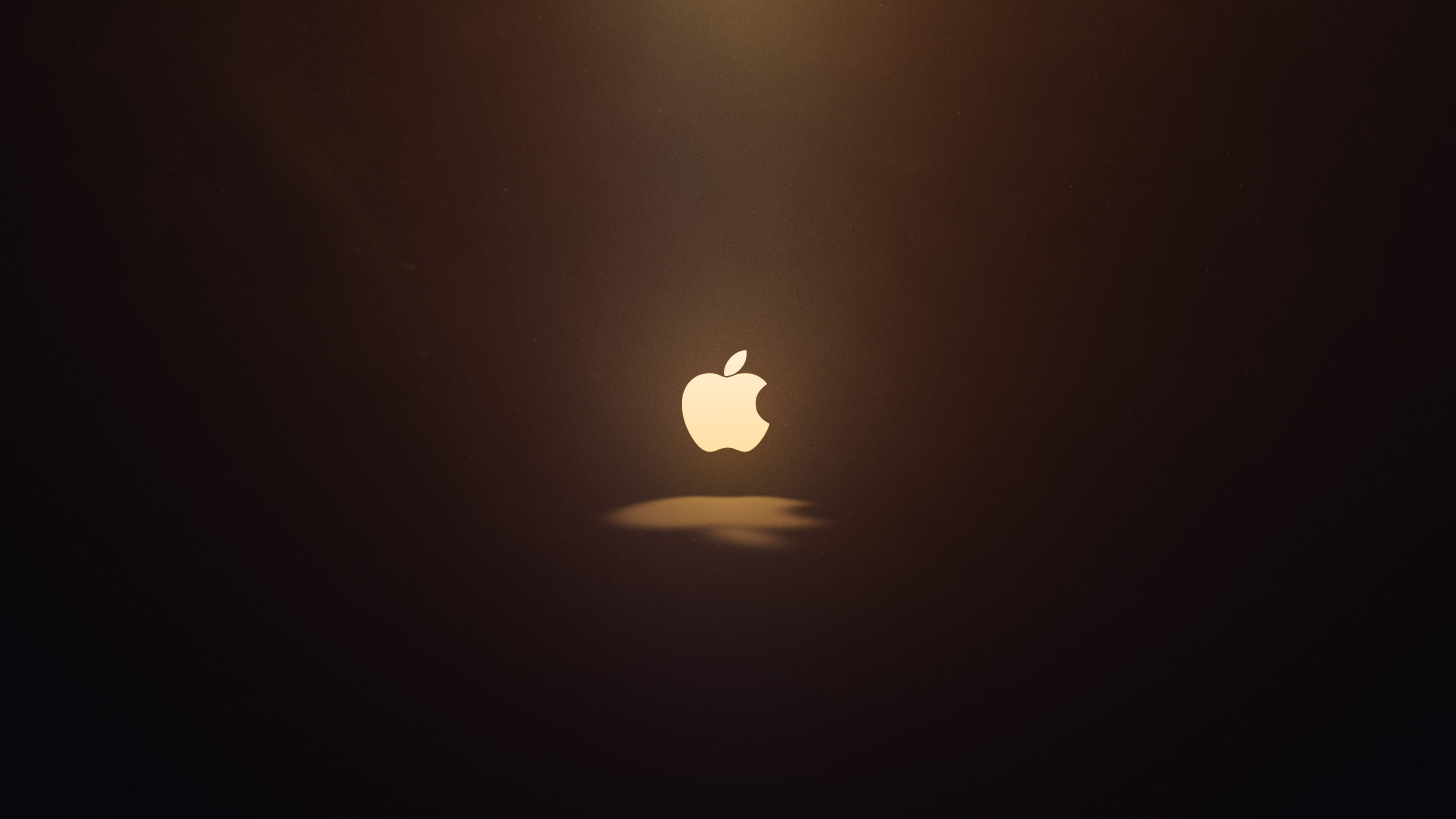 Apple logo illuminated against a dark background HD Wallpaper