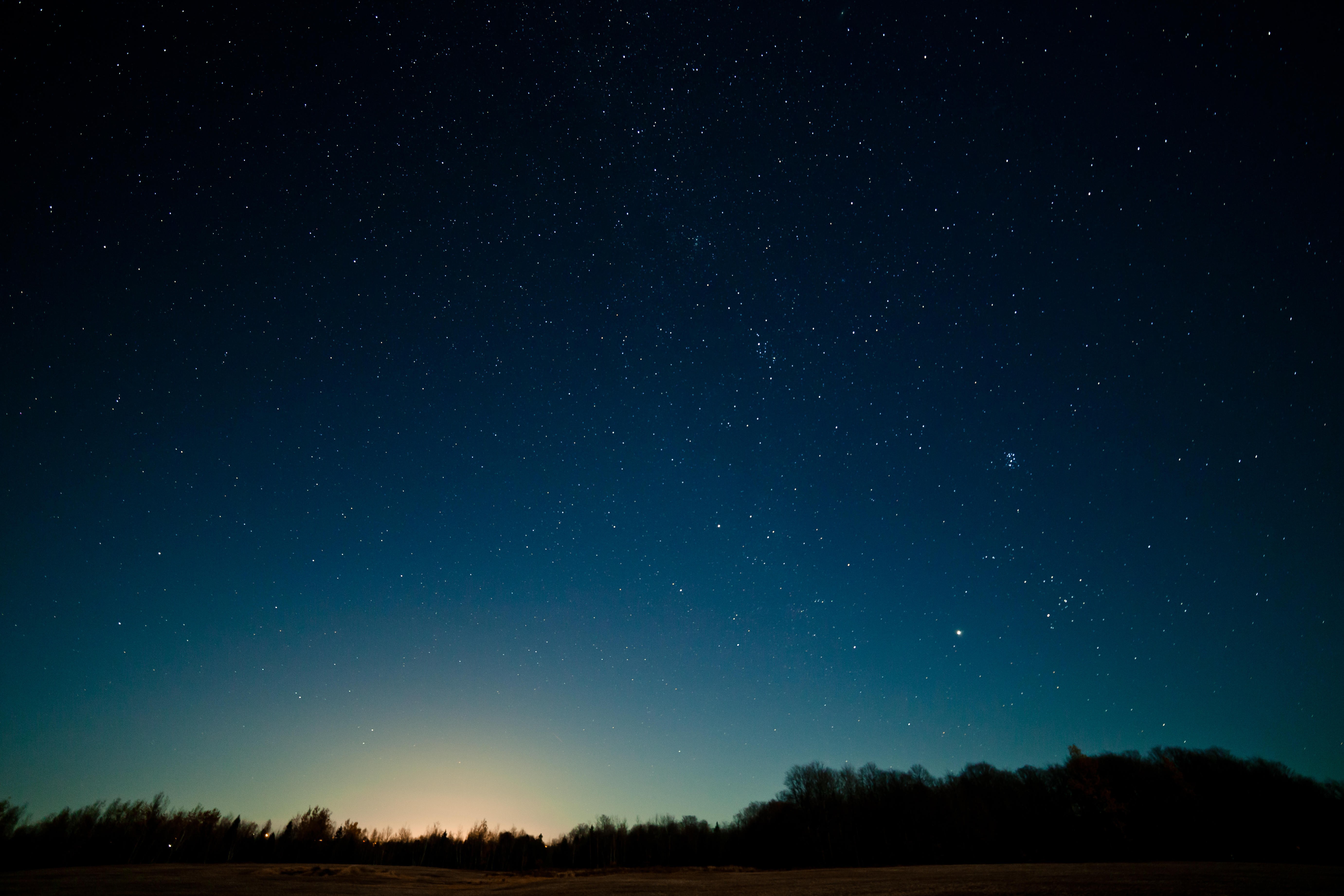 Starry night sky over a dark landscape HD Wallpaper