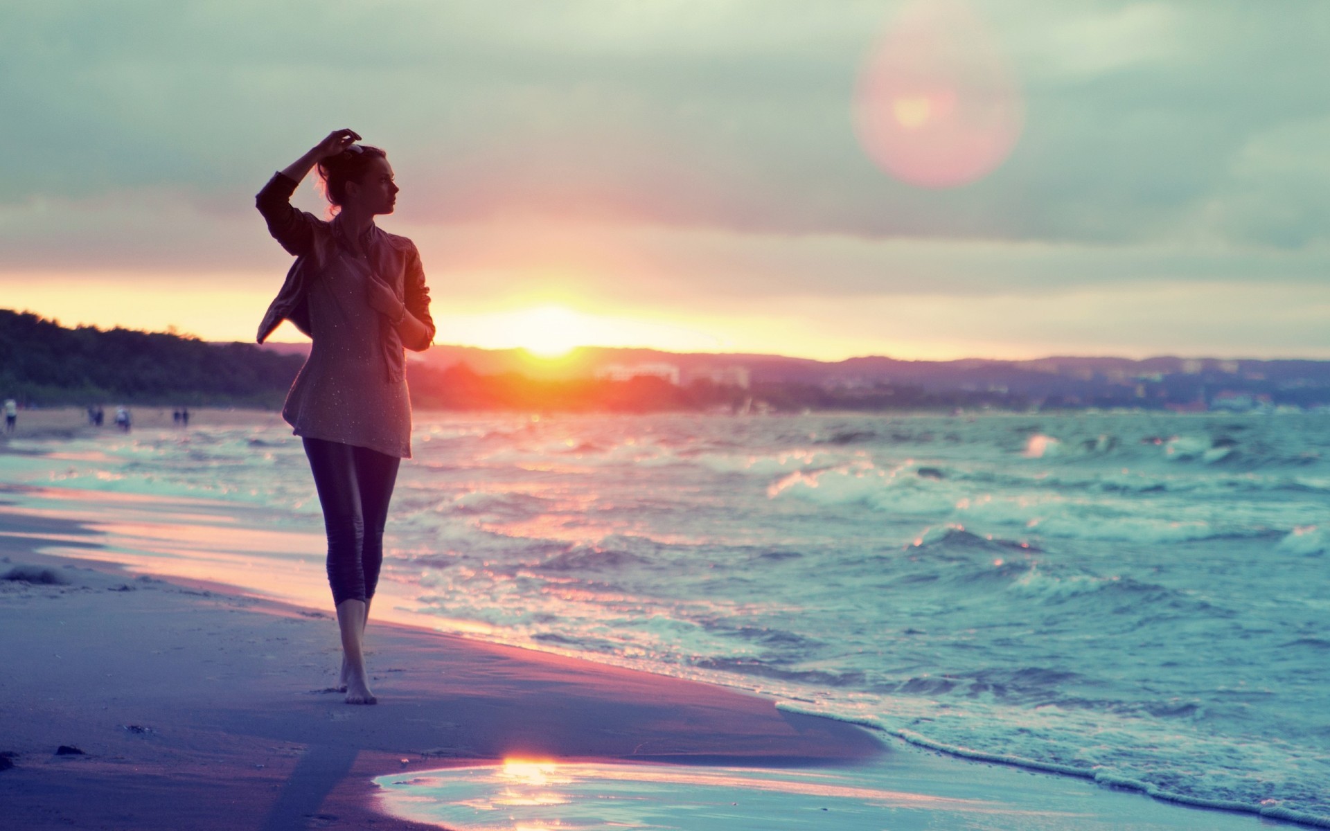 Woman walking on a beach at sunset HD Wallpaper
