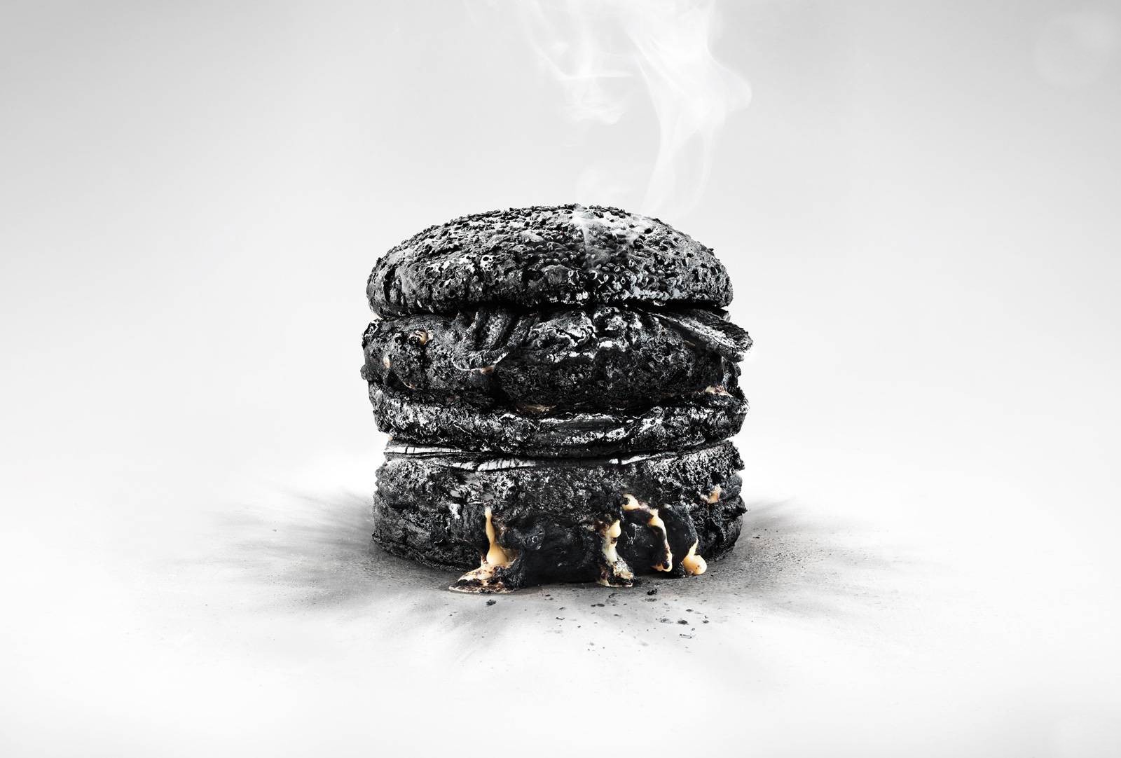 Burnt hamburger with melting cheese and smoke HD Wallpaper