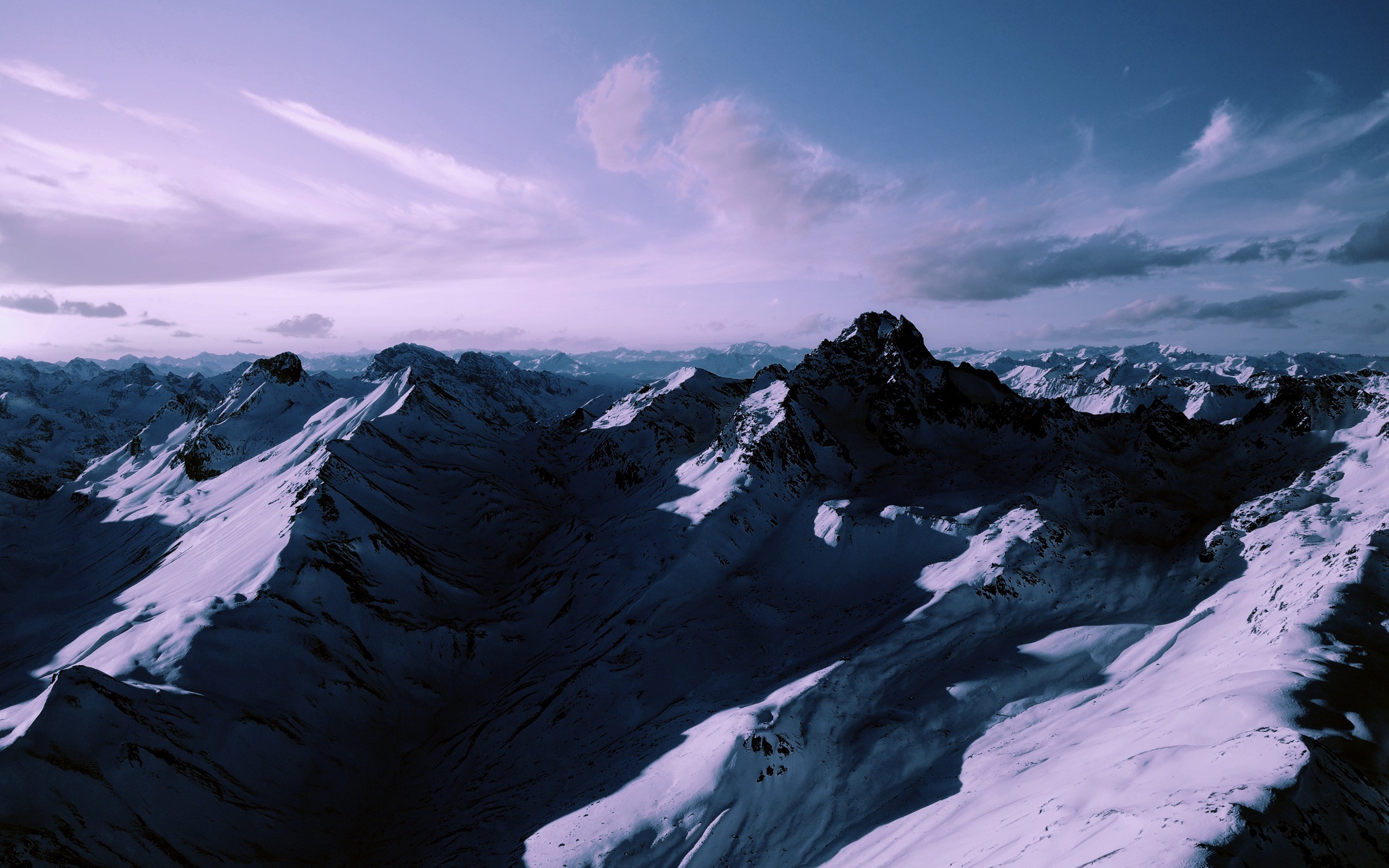 Snow-covered mountains under a purple sky HD Wallpaper