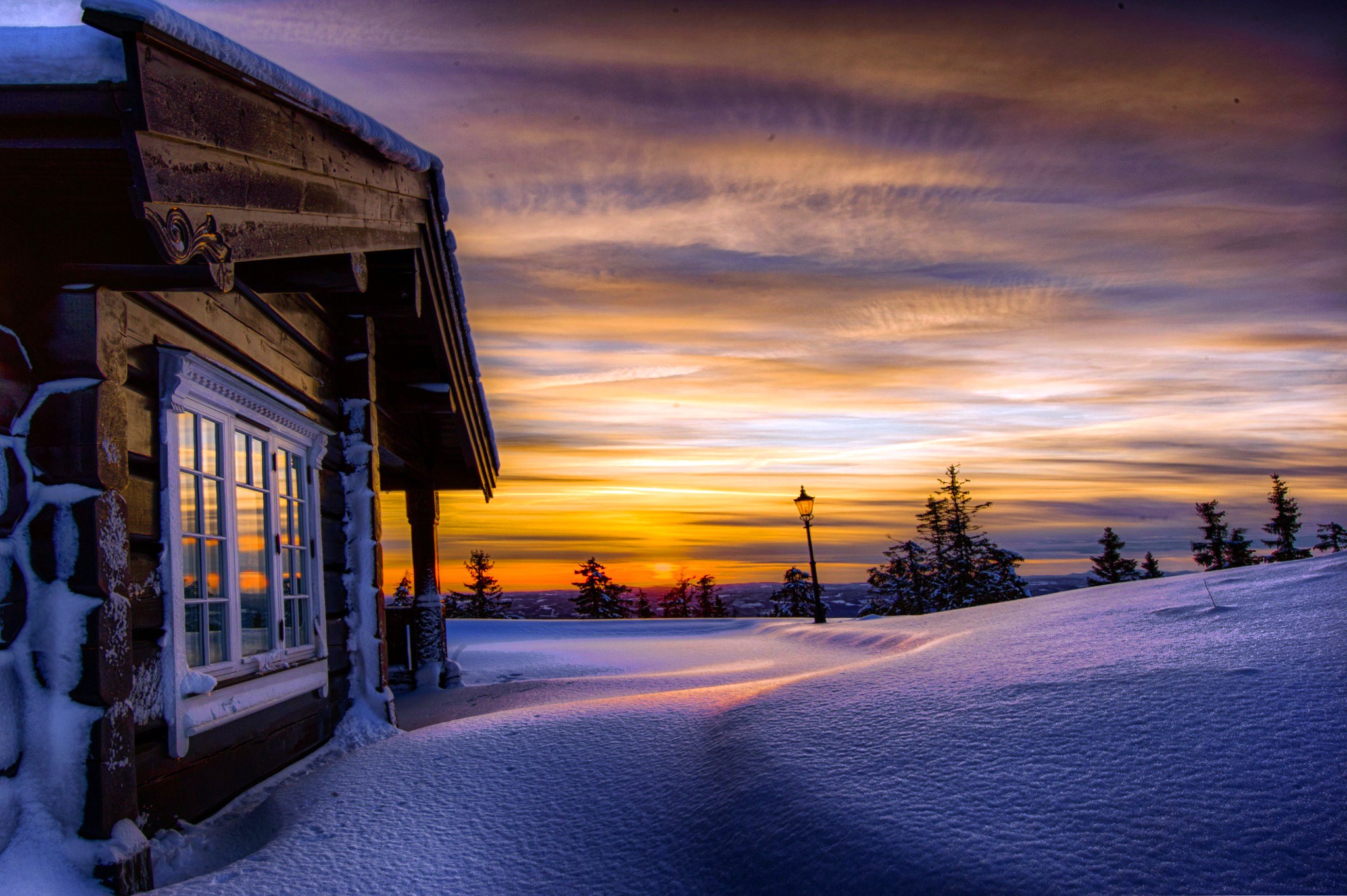 Log cabin in snowy landscape at sunset HD Wallpaper