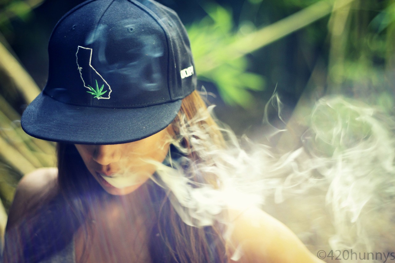 Woman wearing California hat smoking HD Wallpaper