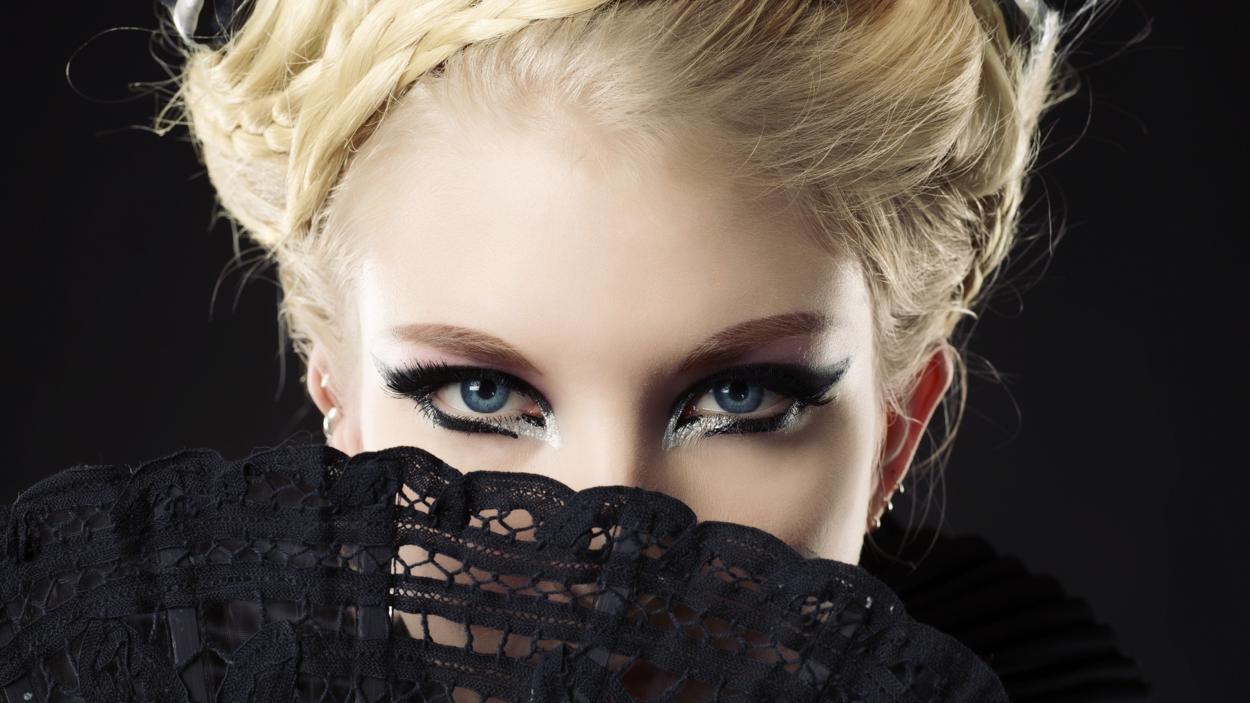 Woman with blue eyes and blonde hair holding a fan HD Wallpaper