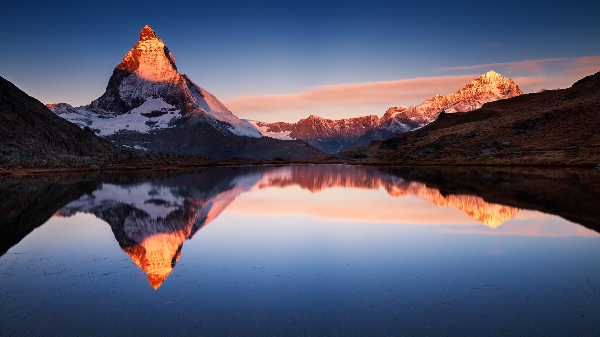 Matterhorn reflected in a calm lake at sunrise HD Wallpaper