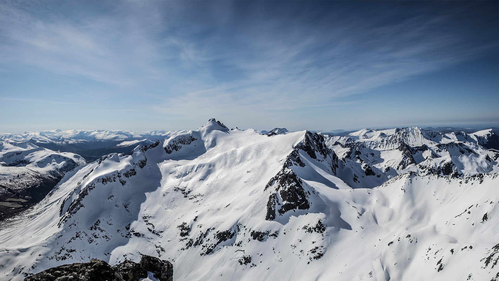 Snow-covered mountains in Kolåstinden, Norway during winter HD Wallpaper