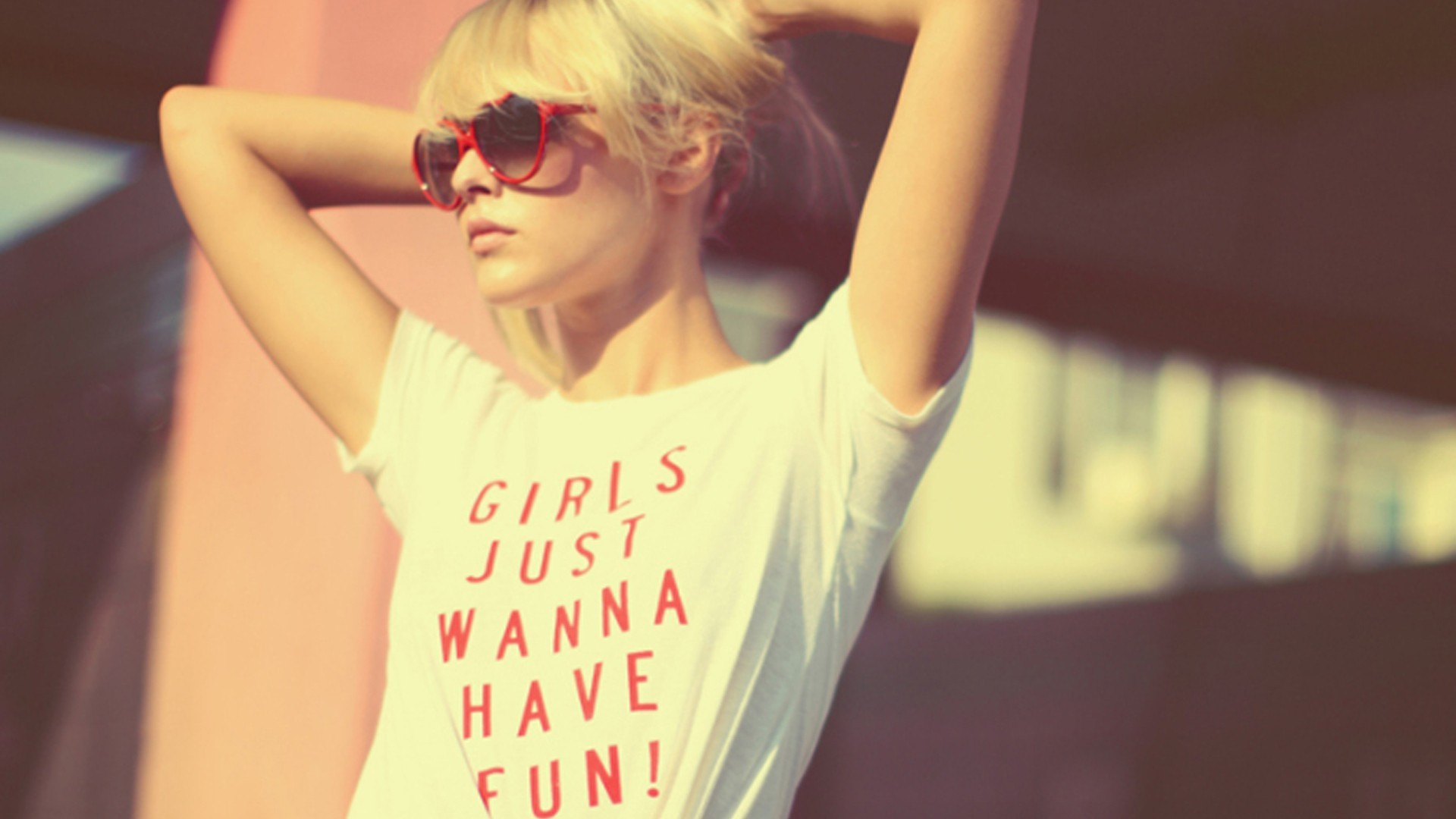 Woman with blonde hair wearing a t-shirt with text HD Wallpaper