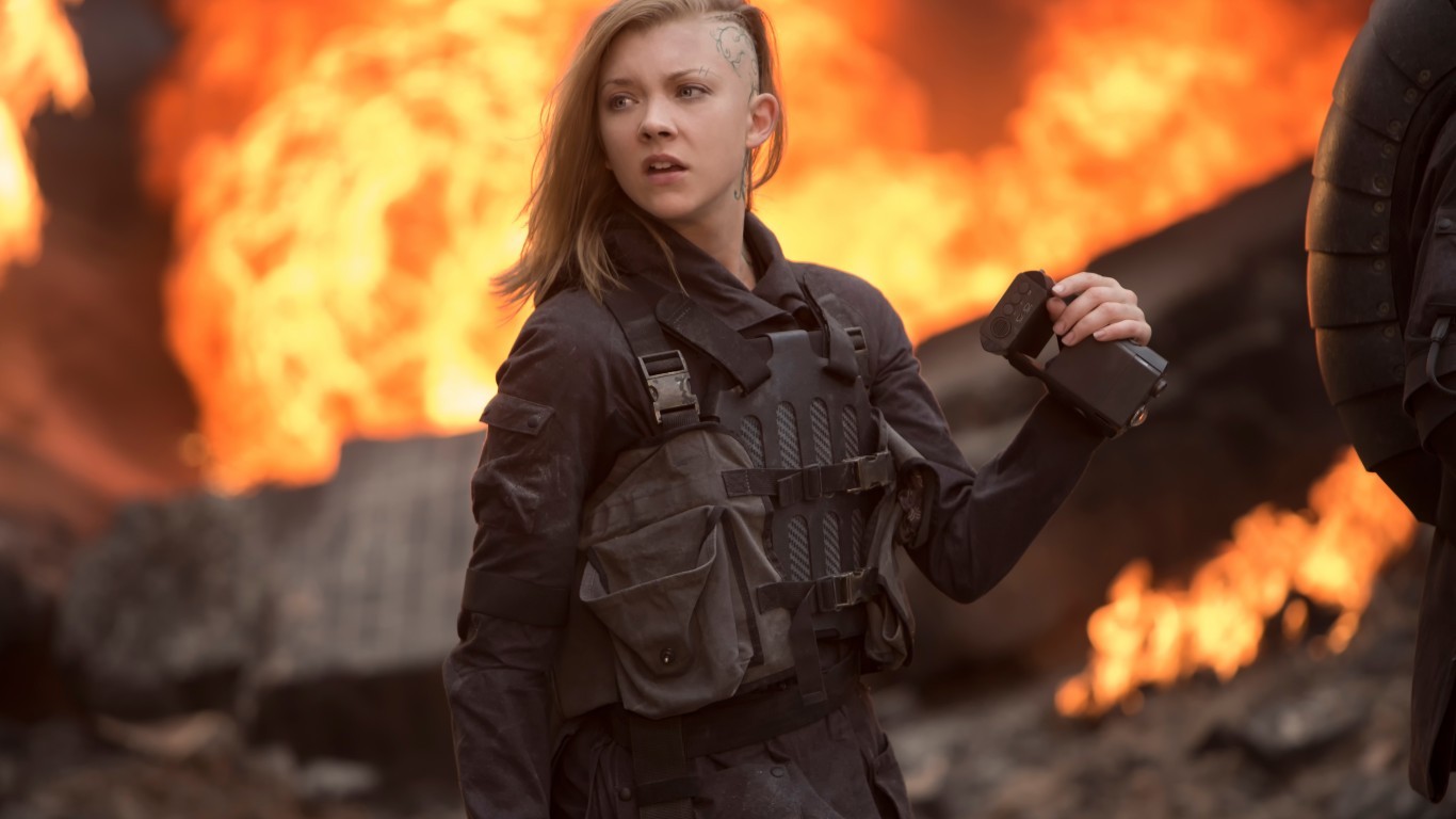 Cressida from The Hunger Games in front of fire HD Wallpaper