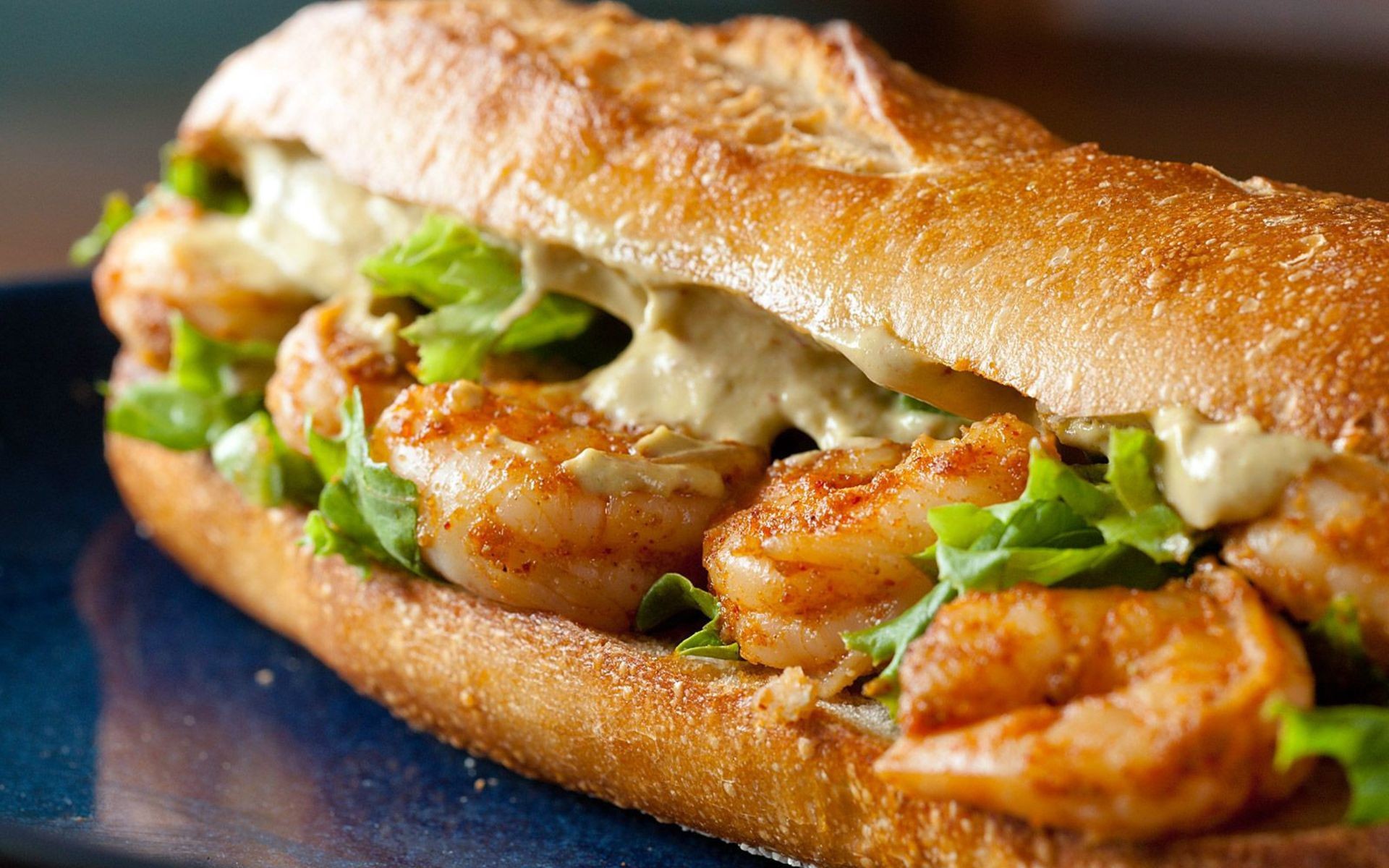 Shrimp sandwich on a baguette with lettuce and sauce HD Wallpaper