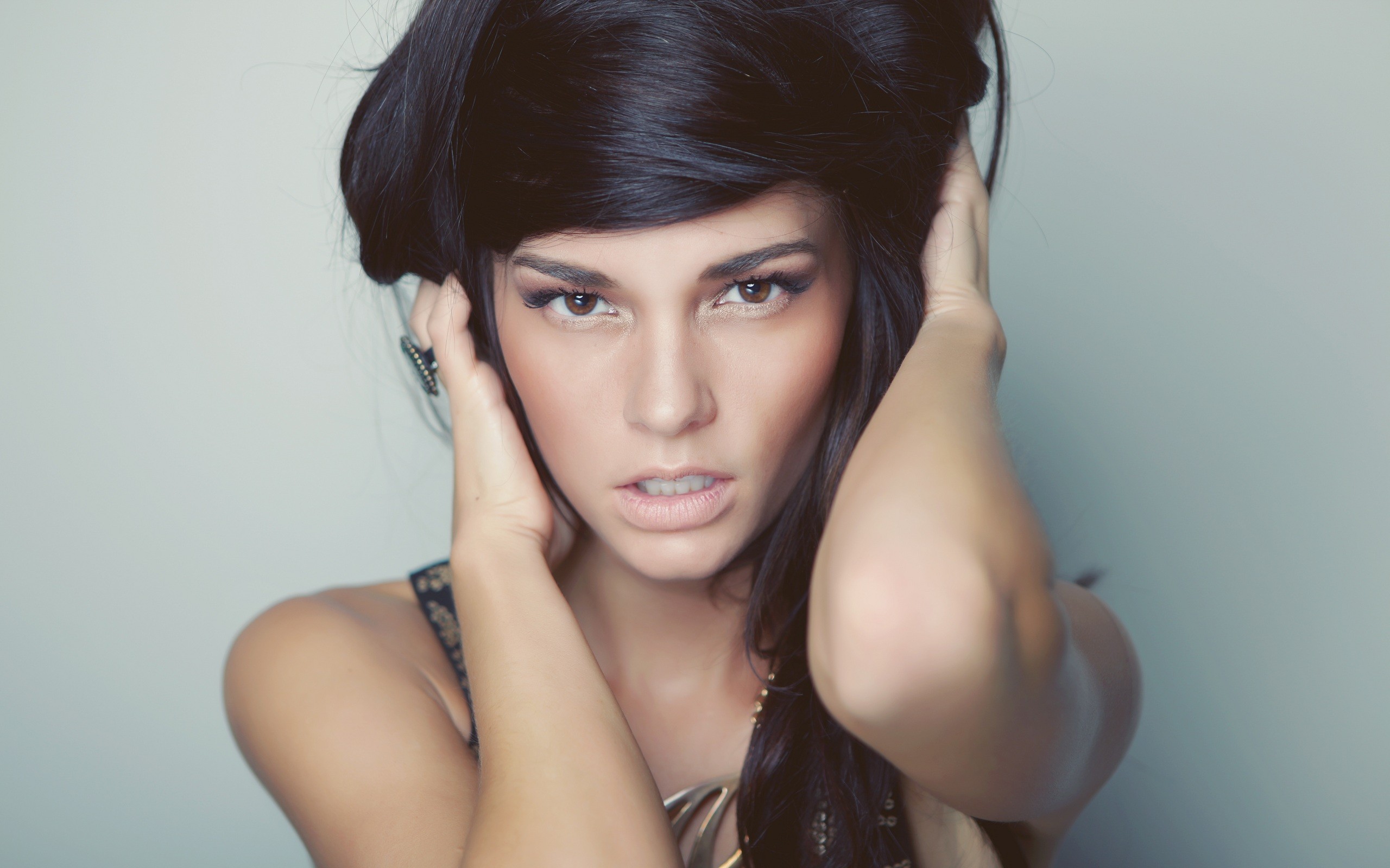 Woman with dark hair and makeup HD Wallpaper