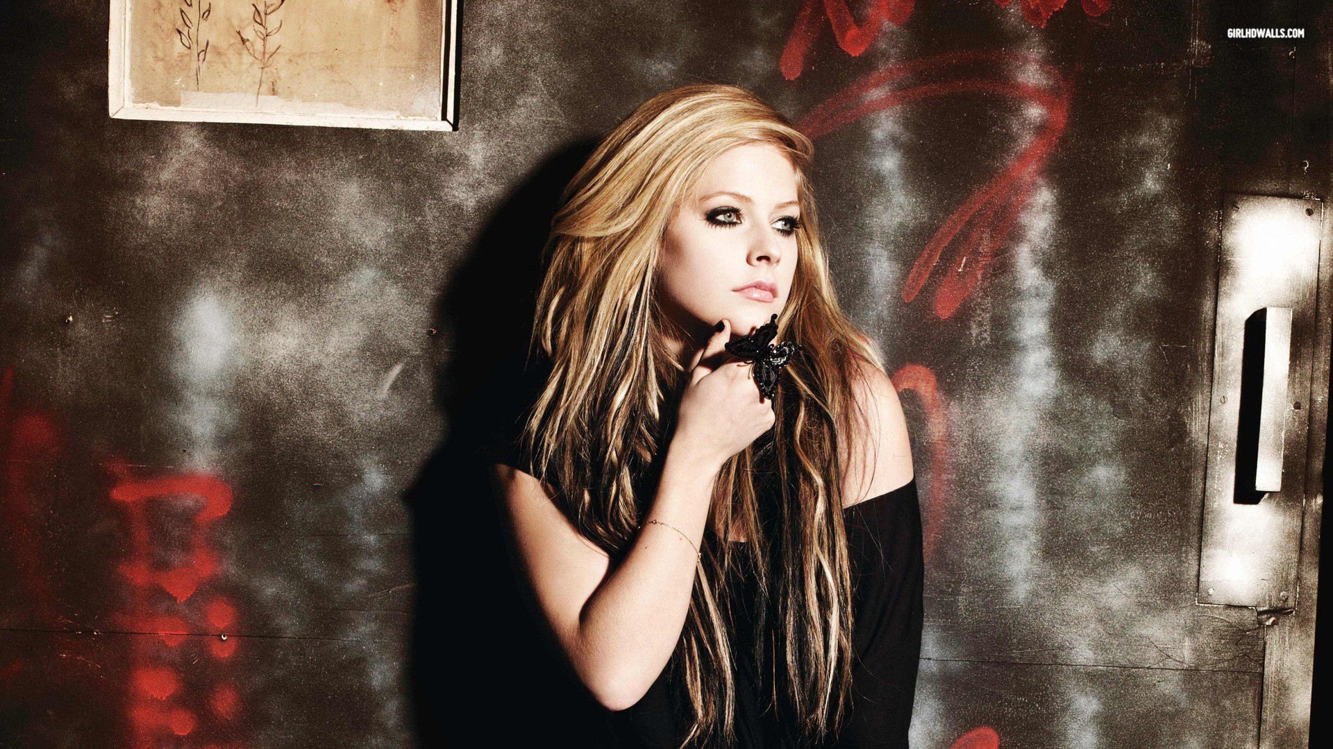 Avril Lavigne posing against a graffiti-covered wall HD Wallpaper