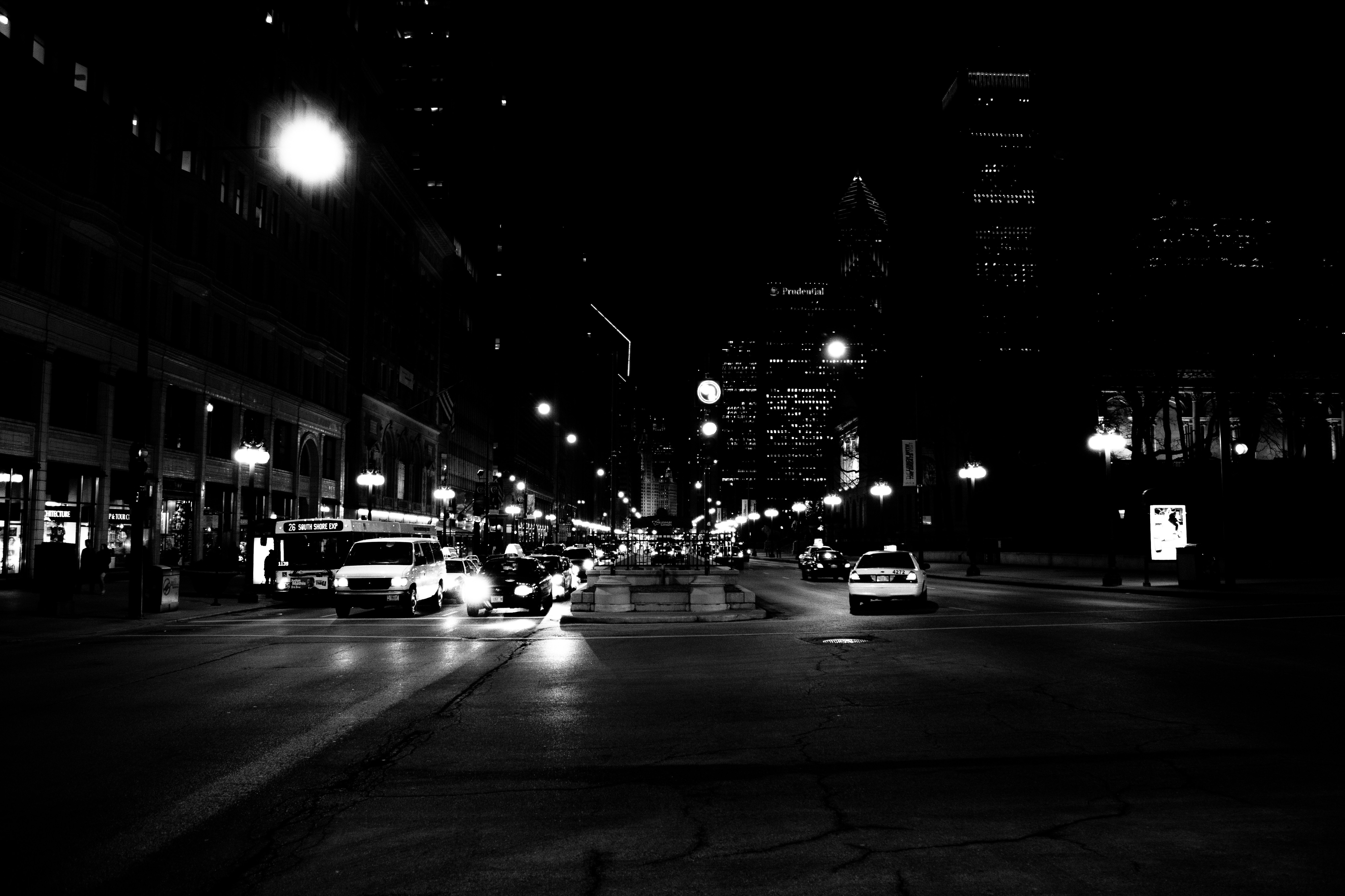 Nighttime city street with traffic and buildings HD Wallpaper