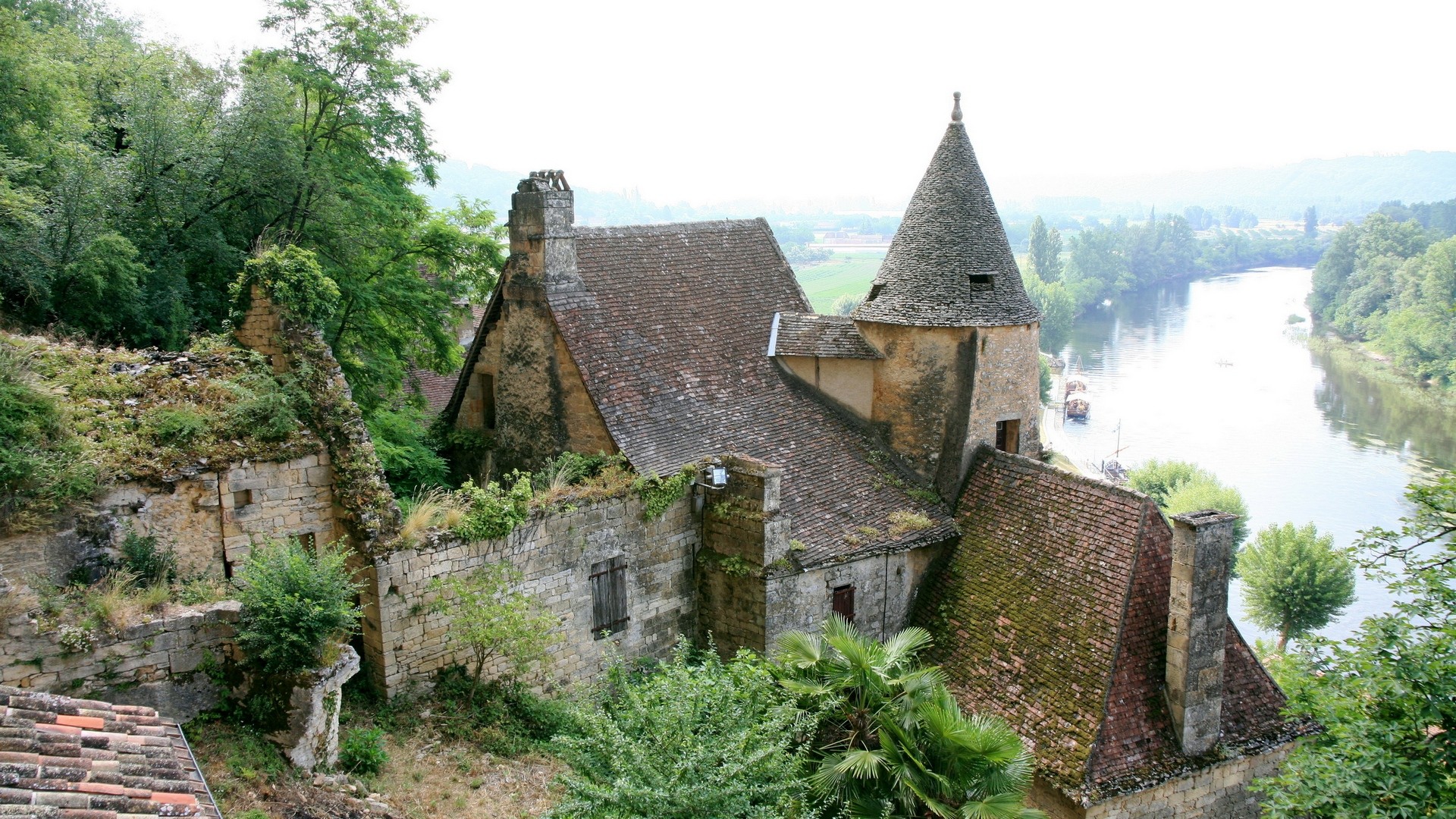 Overgrown ruins of a house by a river HD Wallpaper