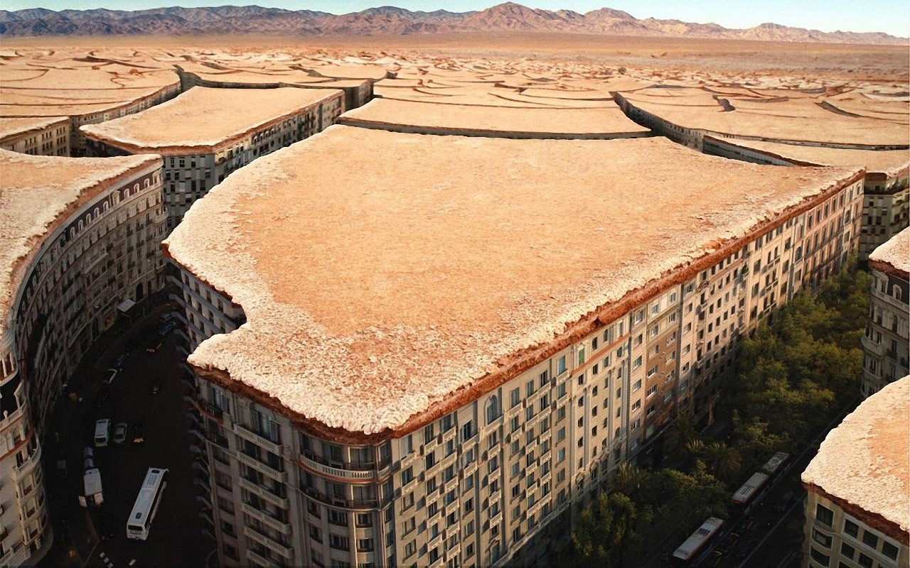 Cracked desert landscape over city buildings HD Wallpaper