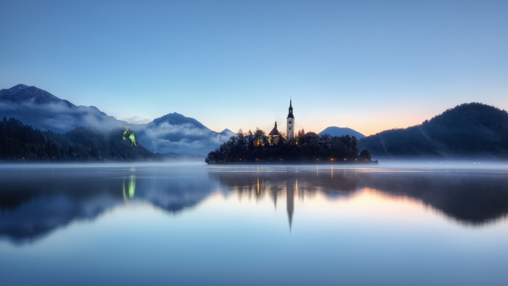 Island church with mountains and lake reflection HD Wallpaper