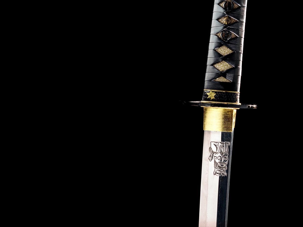 Close-up of a katana sword with dragon engraving HD Wallpaper