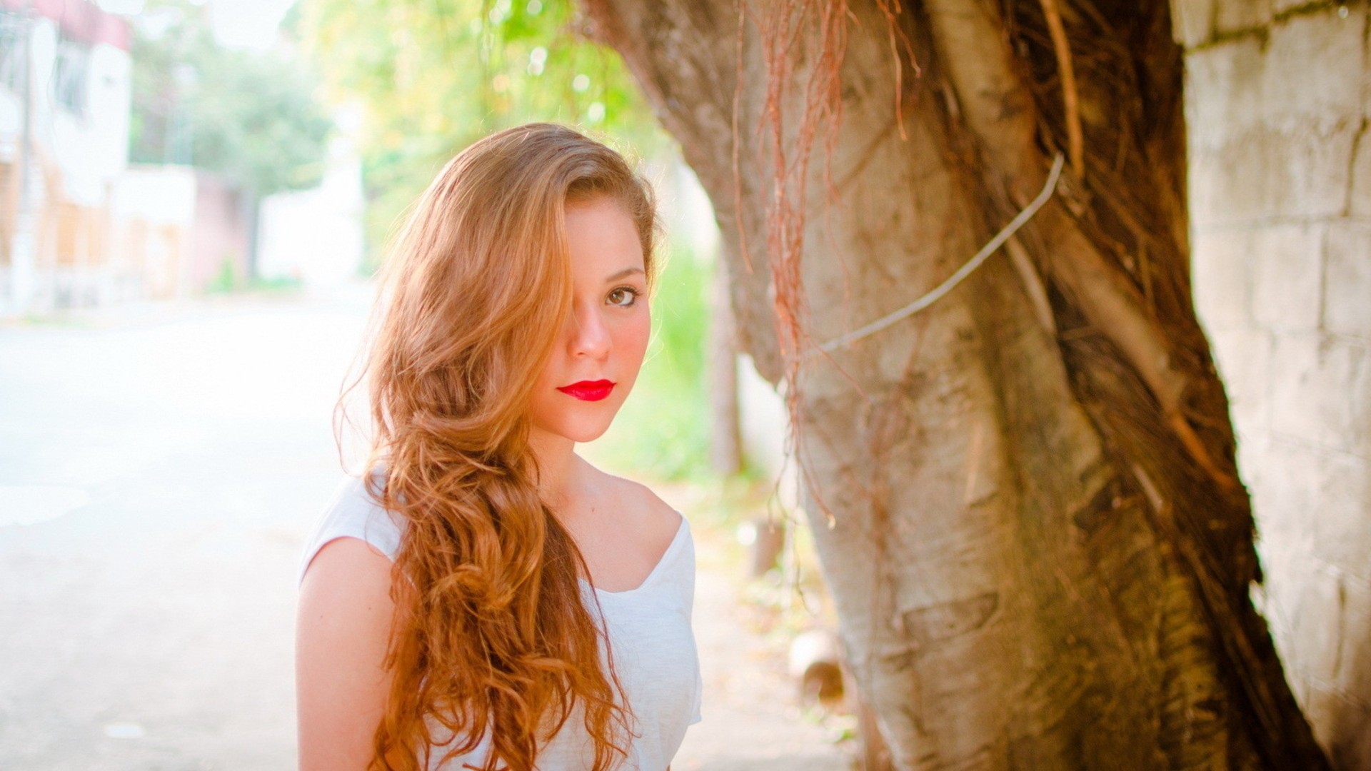 Woman with red lipstick and long hair outdoors HD Wallpaper