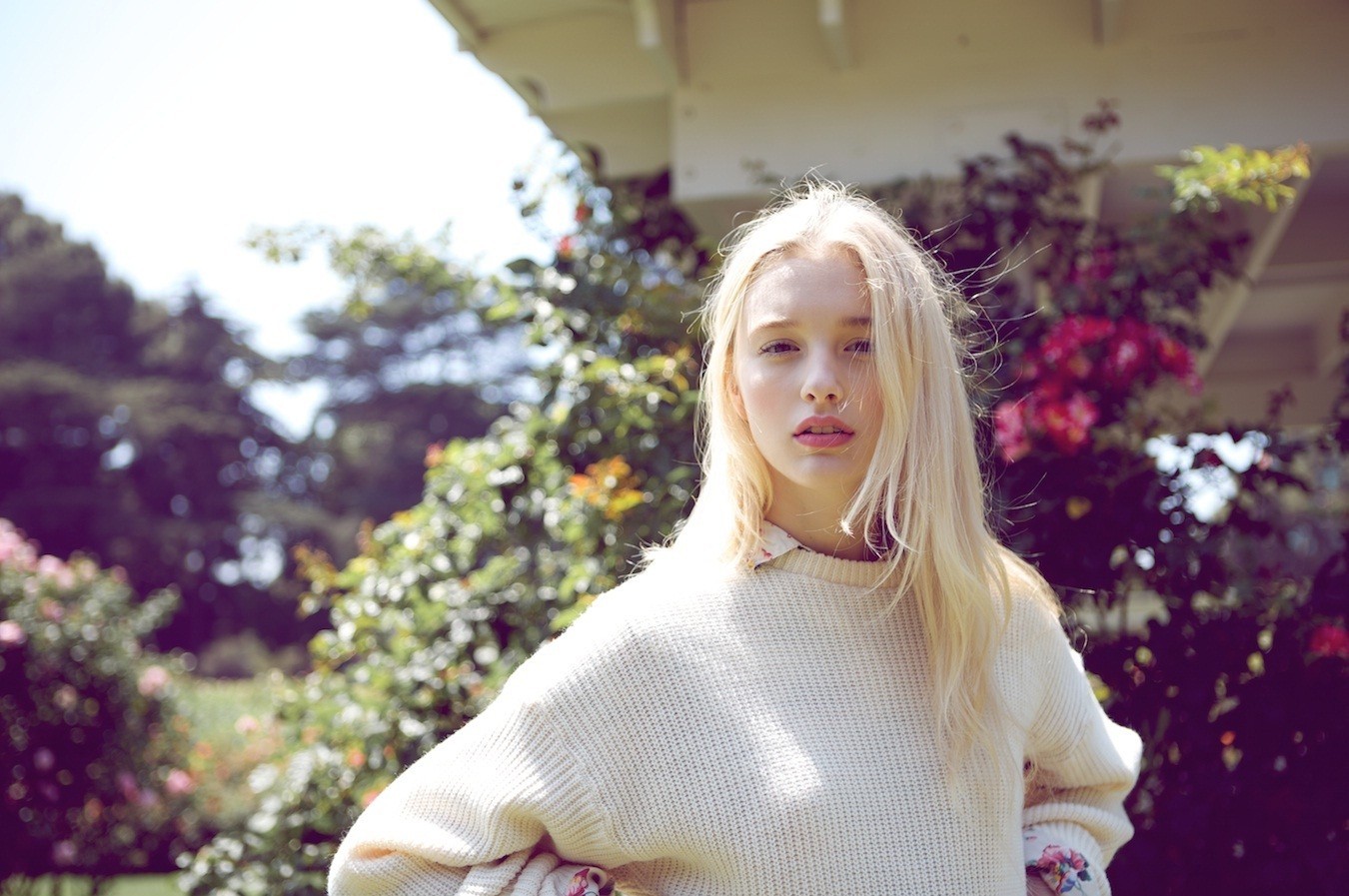 Woman with platinum blonde hair wearing a sweater outdoors HD Wallpaper