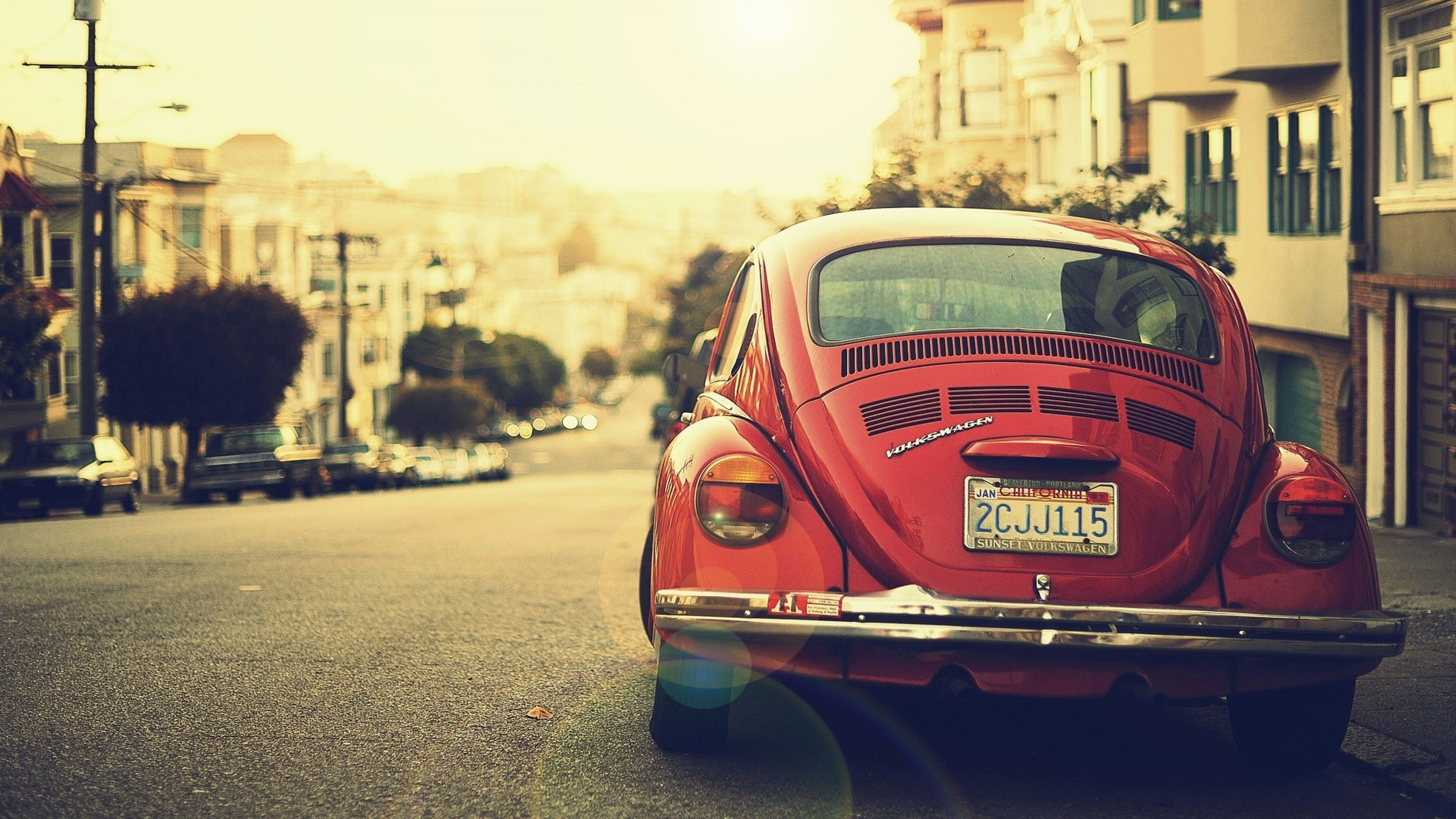 Red Volkswagen Beetle parked on a San Francisco street HD Wallpaper