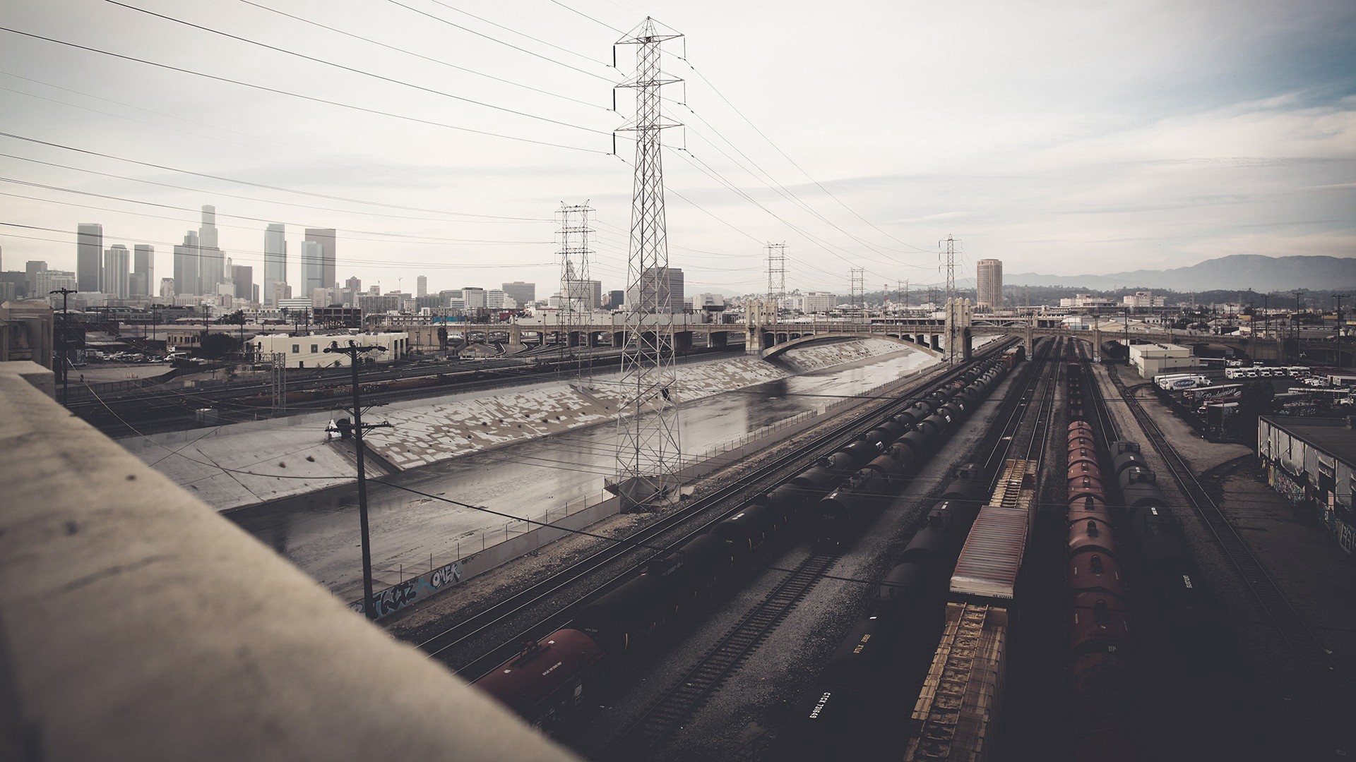 Los Angeles cityscape with trains and power lines HD Wallpaper