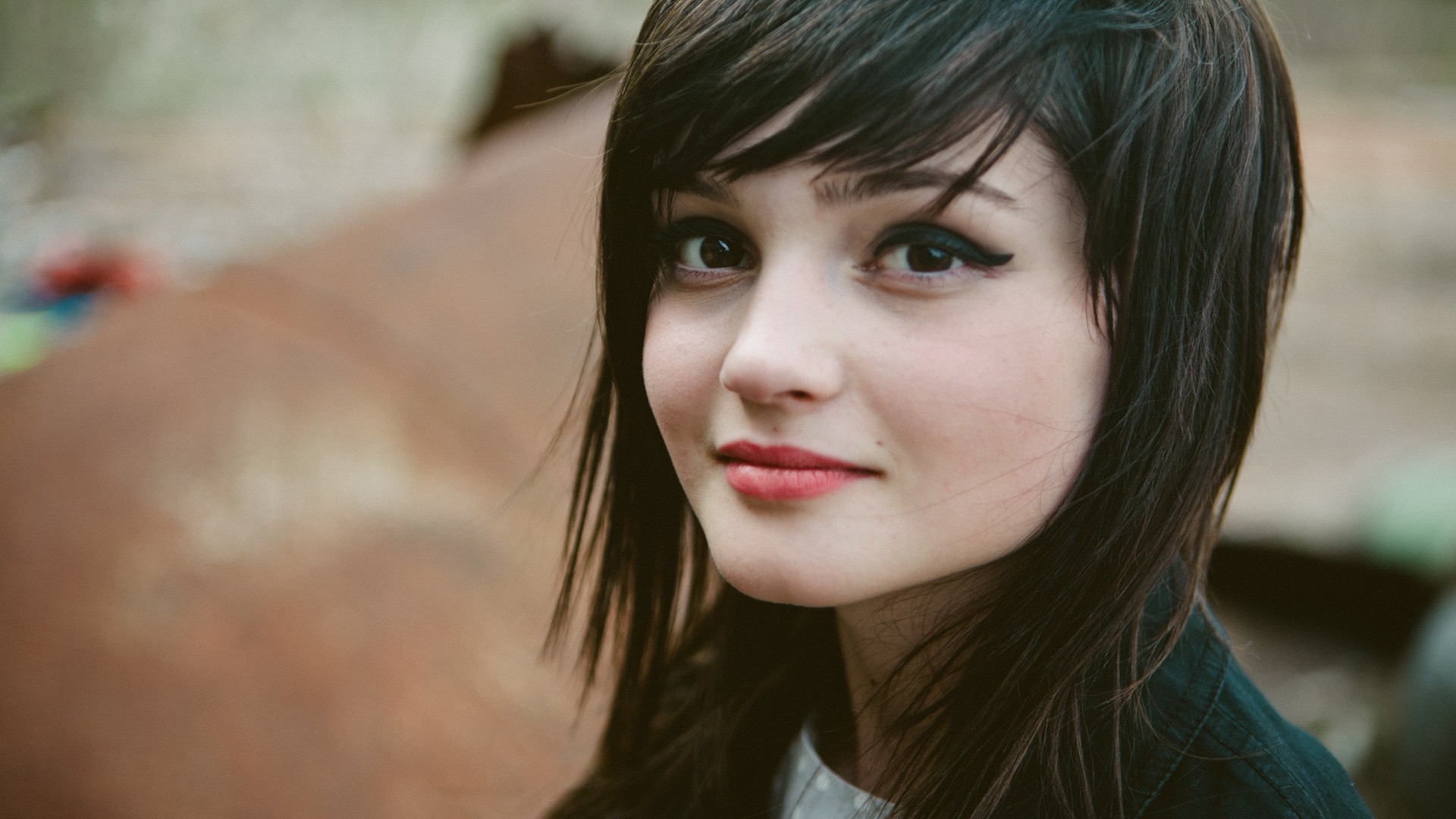 Young woman with dark hair and makeup HD Wallpaper