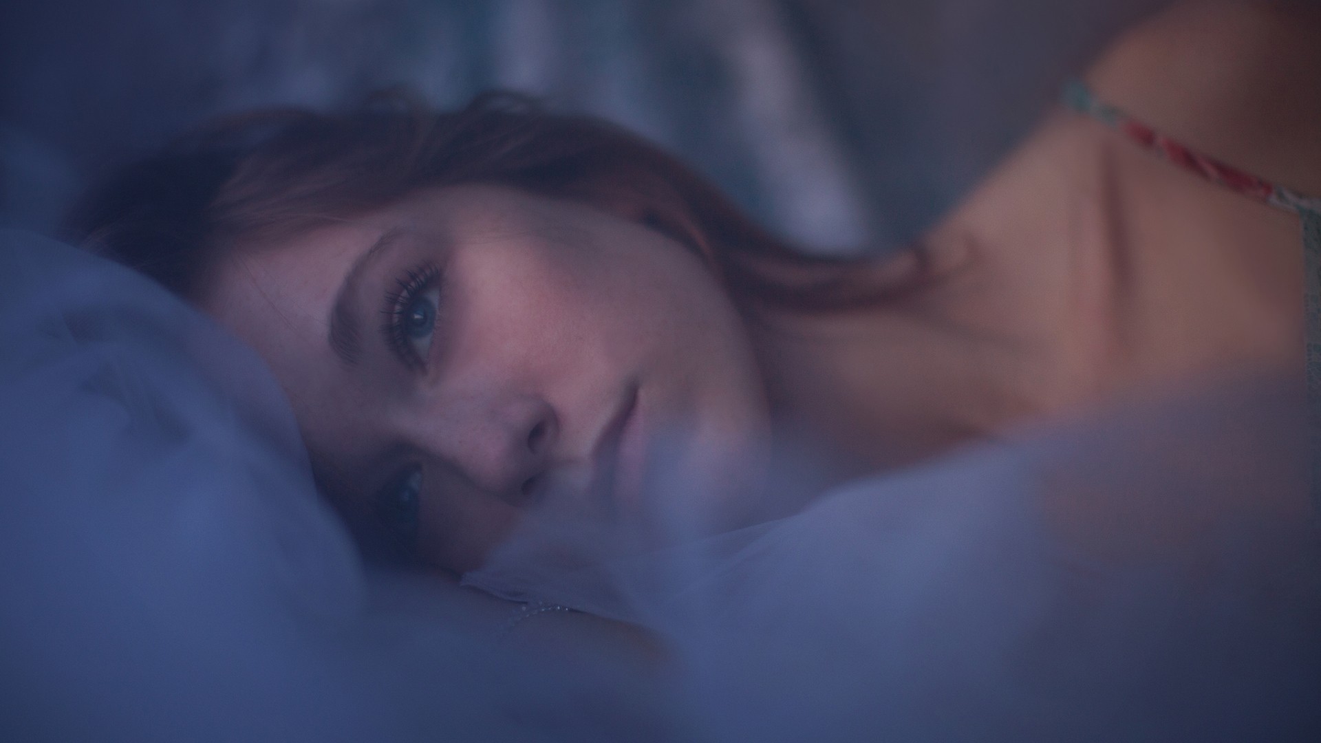 Woman lying in bed with sheer fabric HD Wallpaper