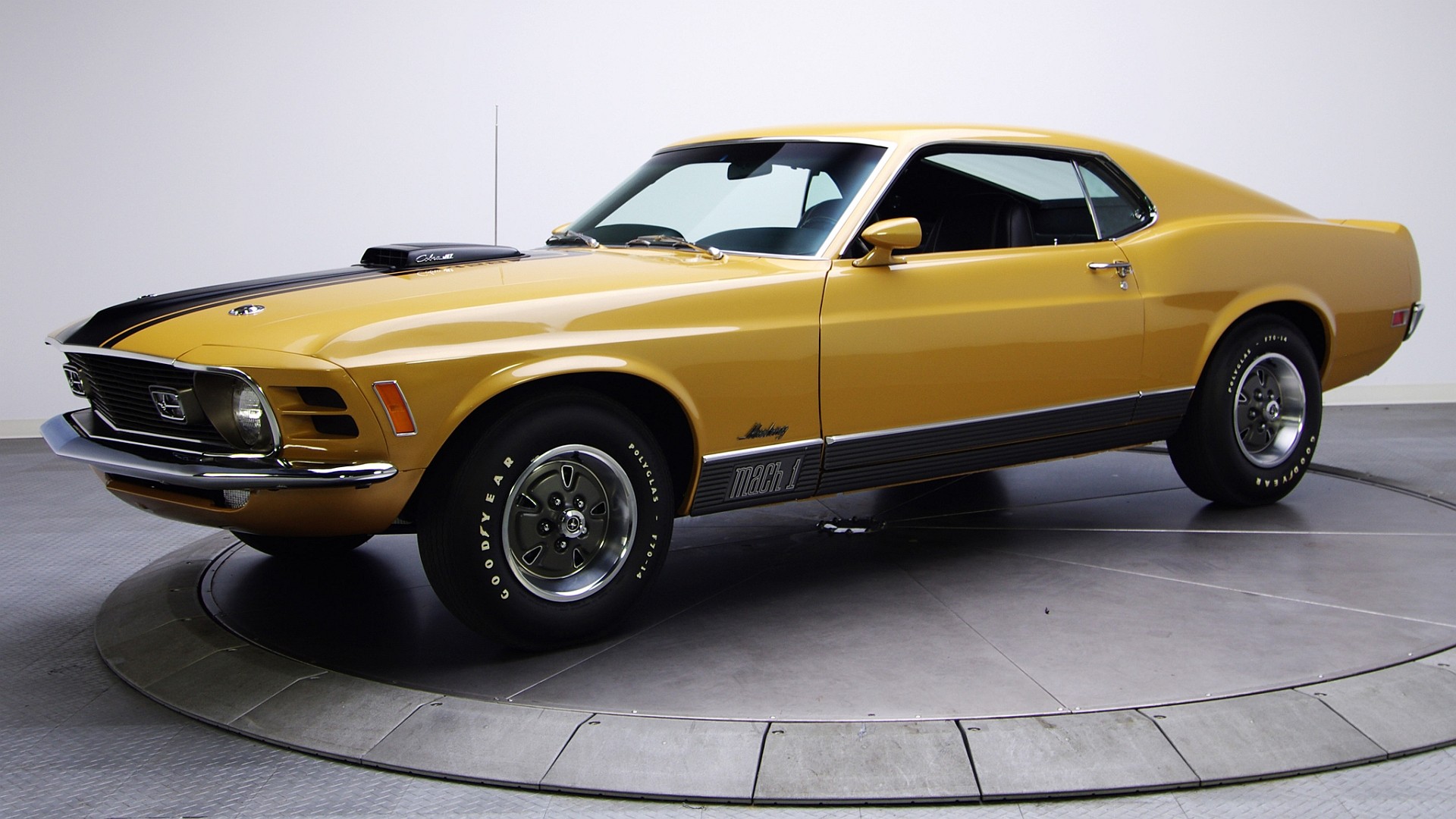 Yellow 1970 Ford Mustang Mach 1 on a turntable HD Wallpaper