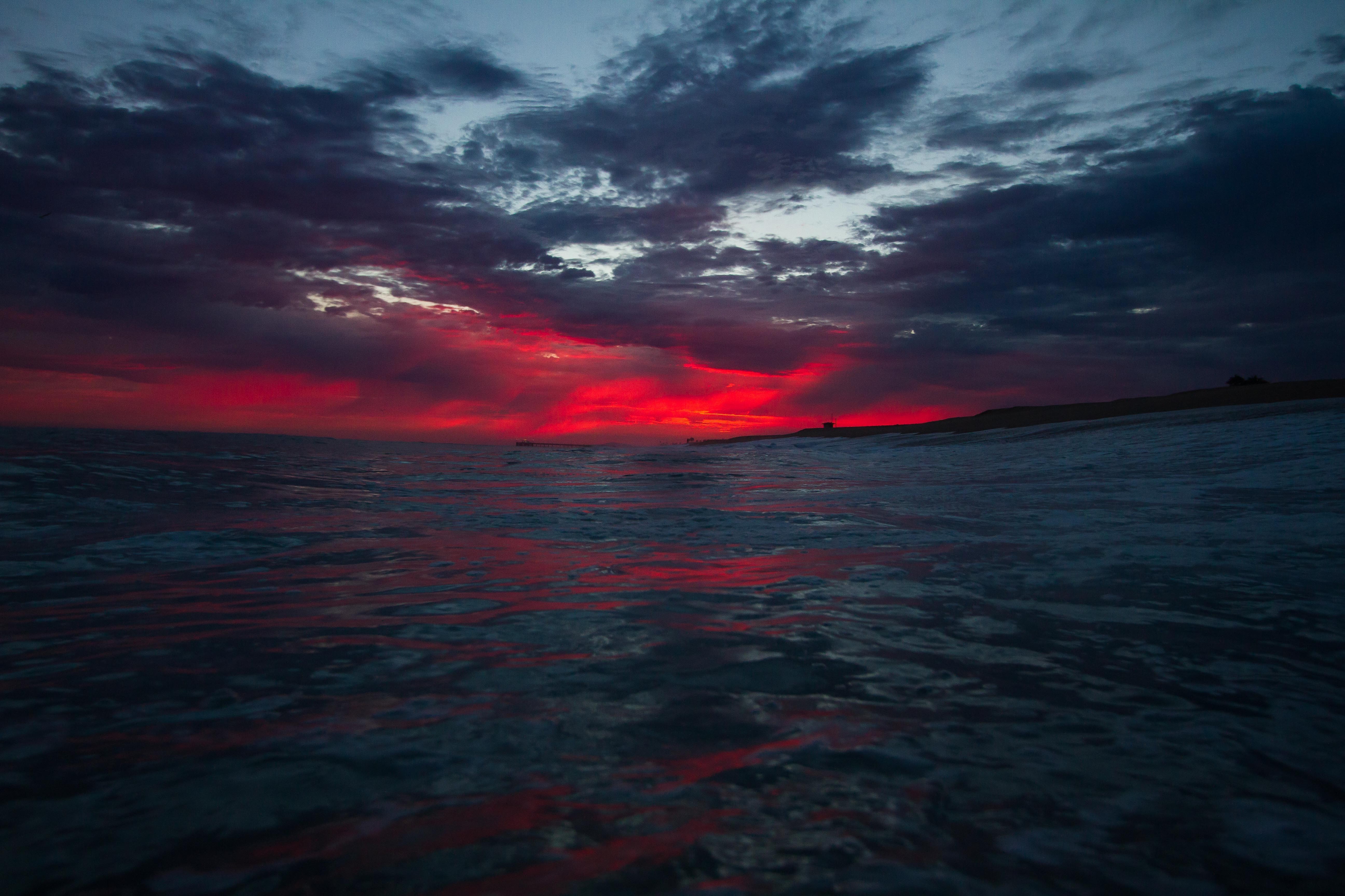 Dramatic sunset over the sea with dark clouds HD Wallpaper
