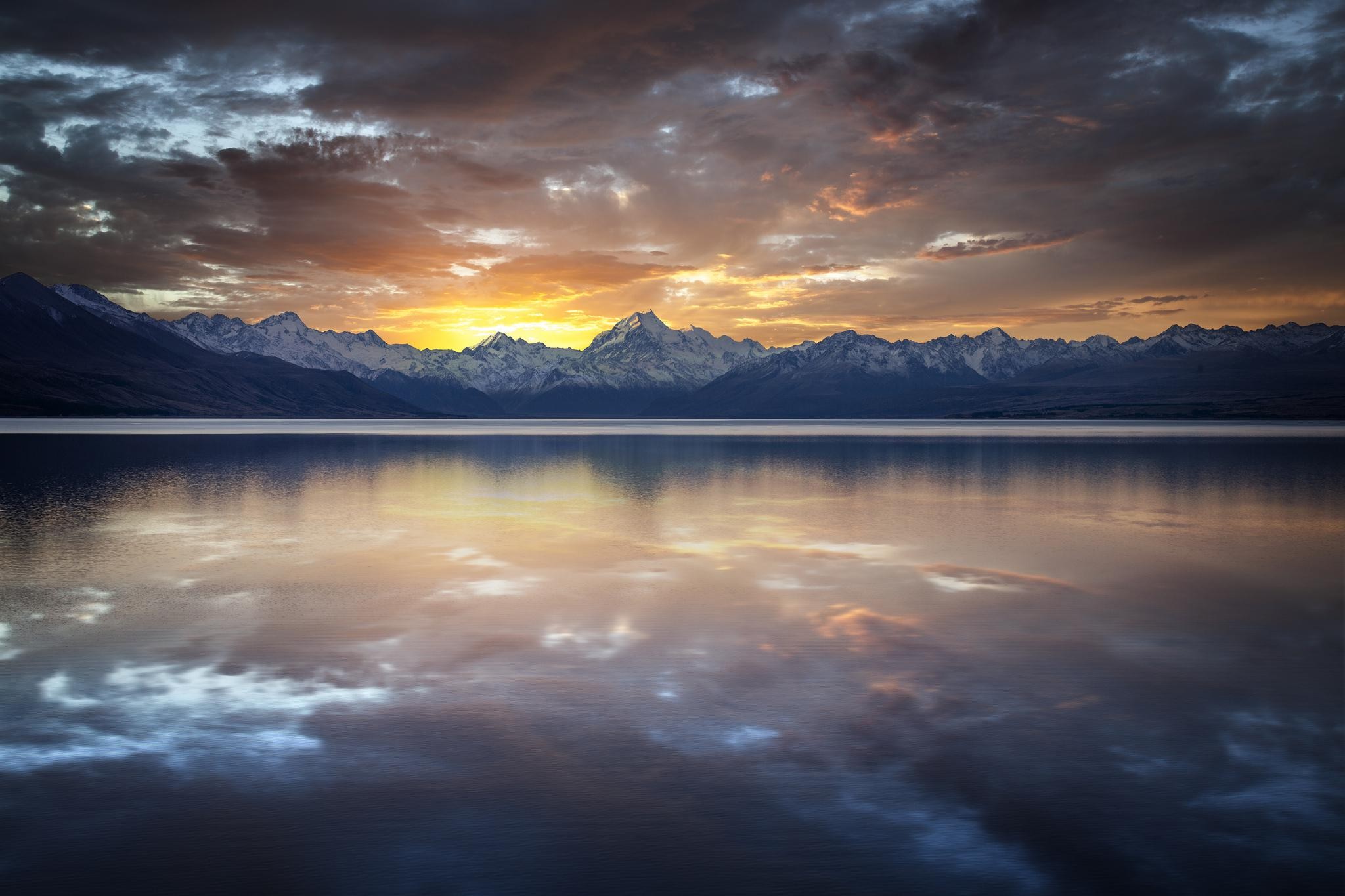 Sunset over snow-capped mountains reflected in a lake HD Wallpaper