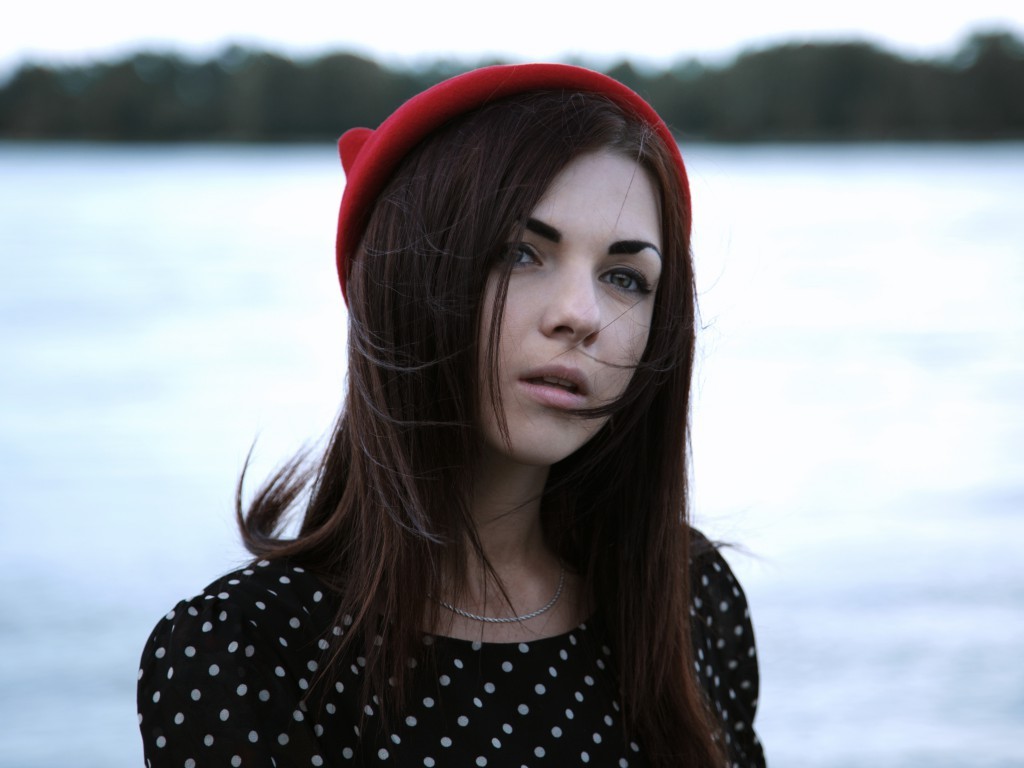 Woman wearing a red hat and polka dot dress outdoors HD Wallpaper