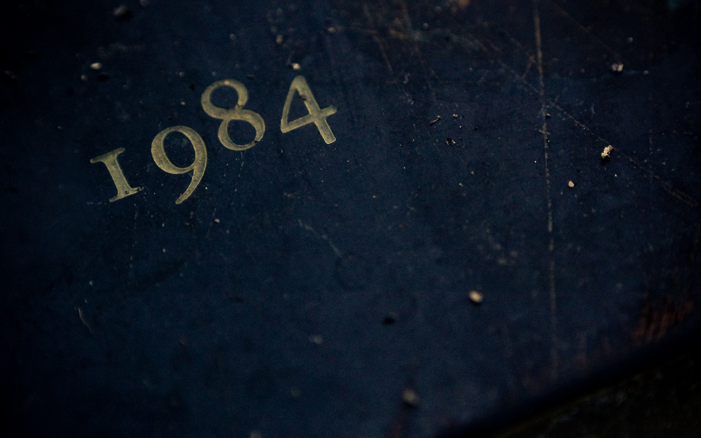 The year 1984 embossed on a dark surface HD Wallpaper